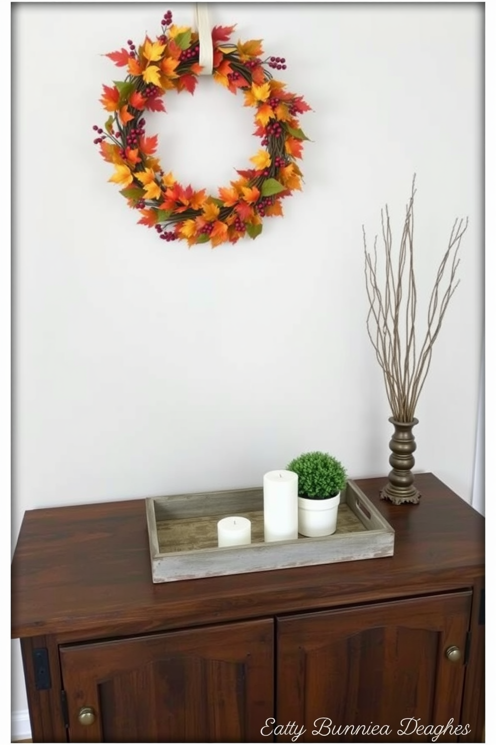 A beautifully styled entryway table adorned with a seasonal table runner featuring autumn leaves in warm hues. The table is complemented by a decorative bowl filled with pinecones and a small lantern casting a soft glow.