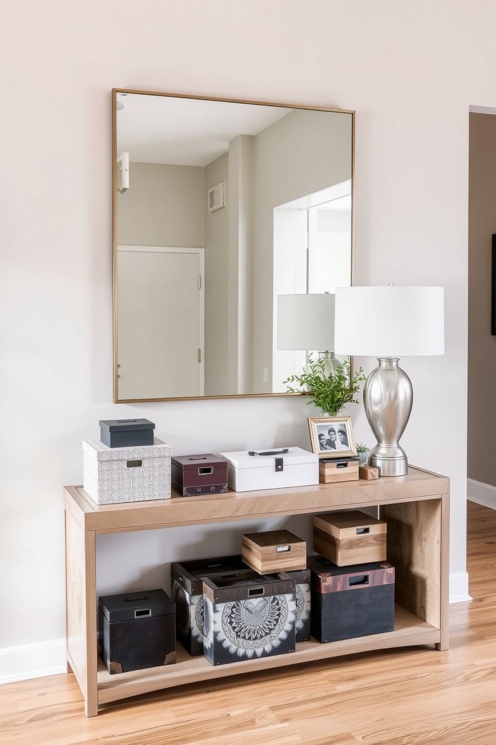 Create a stylish entryway featuring a sleek console table with a mix of textures. The table should be adorned with unique decorative boxes for hidden storage, incorporating a variety of materials such as wood, metal, and ceramic. The wall behind the table can showcase a large mirror to enhance light and space. Add a few carefully selected decorative items like a small plant and a framed photo to create a welcoming atmosphere.