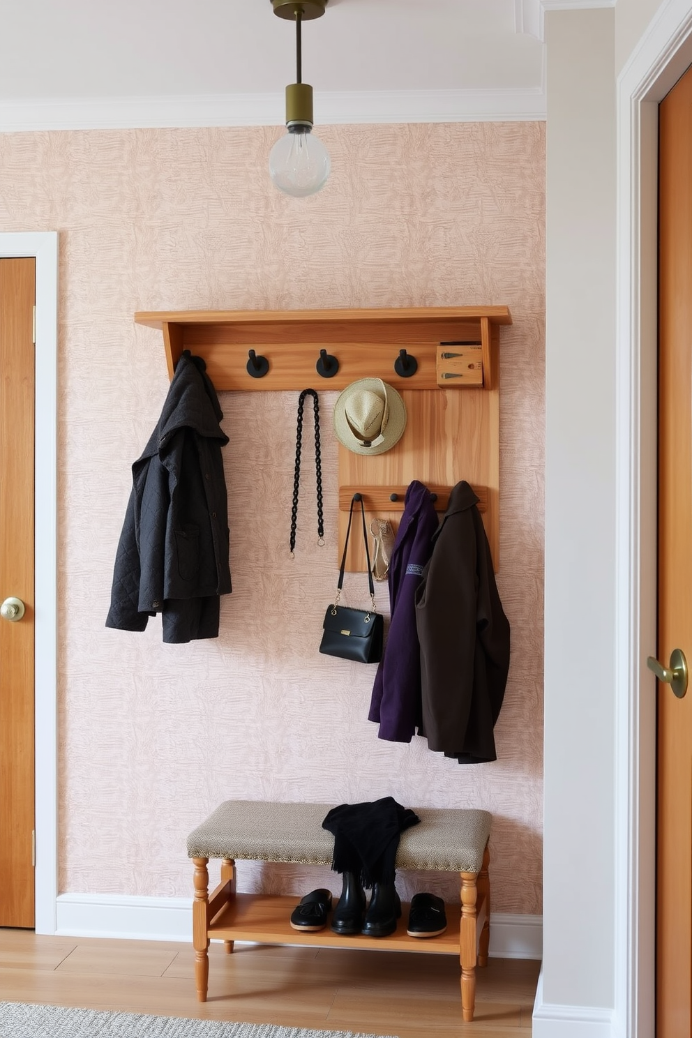 A stylish umbrella stand made of sleek metal sits by the door, complementing the modern aesthetic of the entryway. The wall features a geometric pattern in soft neutrals, creating an inviting and contemporary atmosphere.