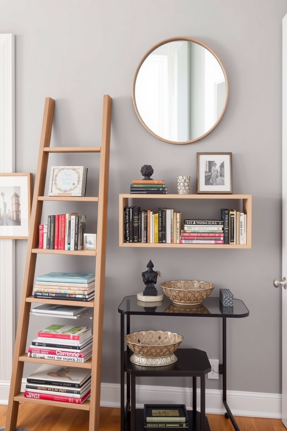 A stylish entryway features a ladder shelf made of natural wood, showcasing an array of books and decorative items. The wall behind the shelf is painted in a soft gray hue, adorned with framed artwork that adds a personal touch to the space. The ladder shelf is positioned next to a small console table, where a decorative bowl holds keys and small essentials. A round mirror hangs above the table, reflecting light and creating a welcoming atmosphere in the entryway.