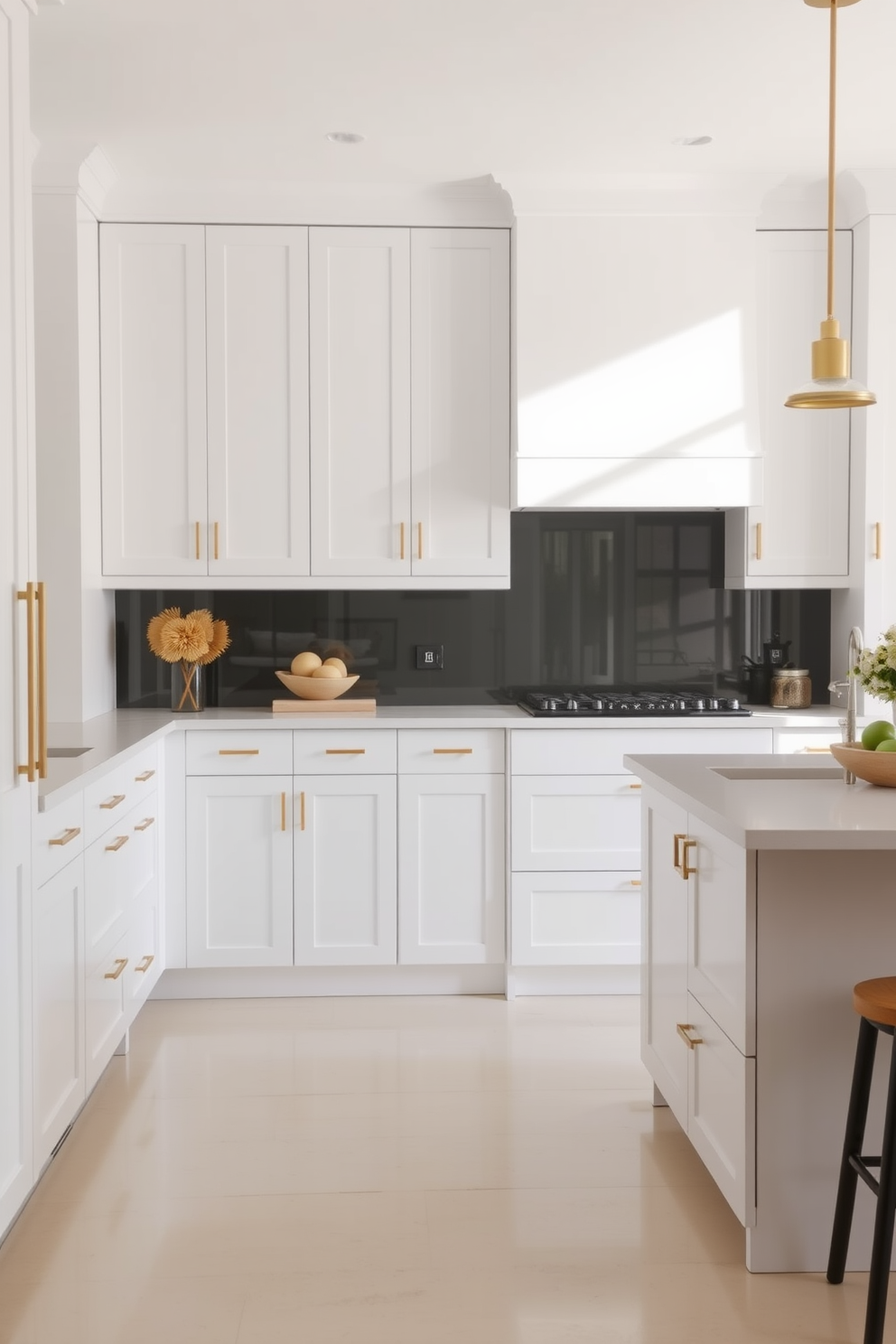 Sleek minimalist cabinetry in white tones creates a clean and airy atmosphere in the kitchen. The space is enhanced by subtle brass hardware and a large central island that doubles as a breakfast bar.