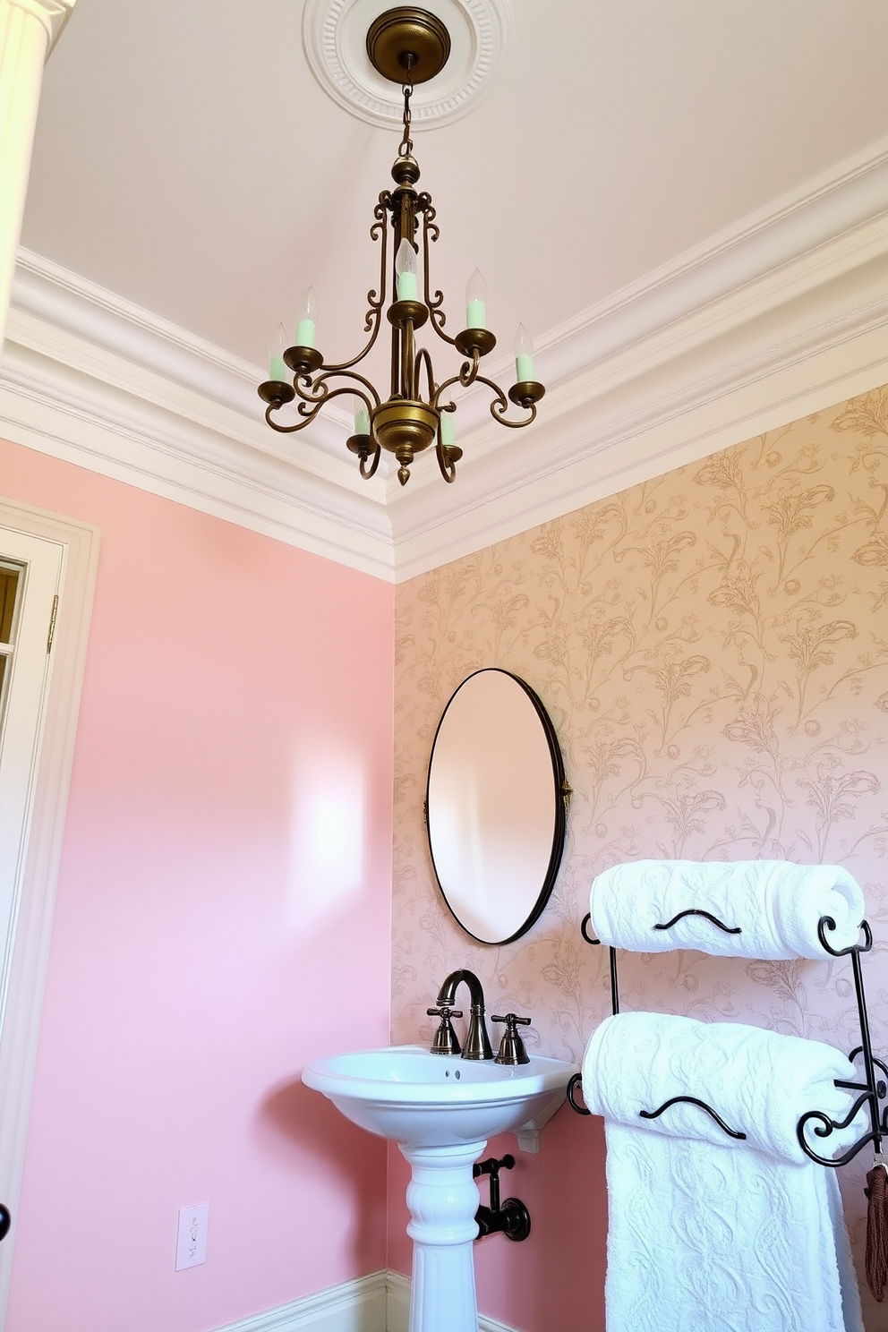 Crown molding elegantly frames the ceiling, adding a touch of sophistication and enhancing the perceived height of the room. The walls are adorned with soft pastel colors, and a vintage chandelier hangs gracefully from above, creating a warm and inviting atmosphere. The powder room features a pedestal sink with intricate detailing and a stylish faucet that complements the overall design. Luxurious wallpaper with a delicate floral pattern envelops the space, while plush towels are neatly arranged on a decorative rack, adding both functionality and charm.