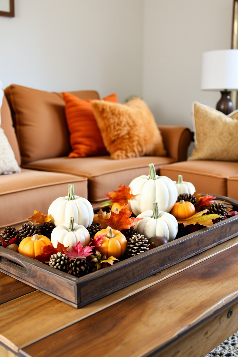 Create a cozy living room setting featuring decorative trays adorned with autumn accents. The trays should include small pumpkins, pinecones, and colorful leaves, arranged artfully on a rustic wooden coffee table. In the background, a warm-toned sofa is complemented by plush throw pillows in shades of orange and gold. Soft lighting from a nearby lamp casts a gentle glow, enhancing the inviting atmosphere of fall decor.