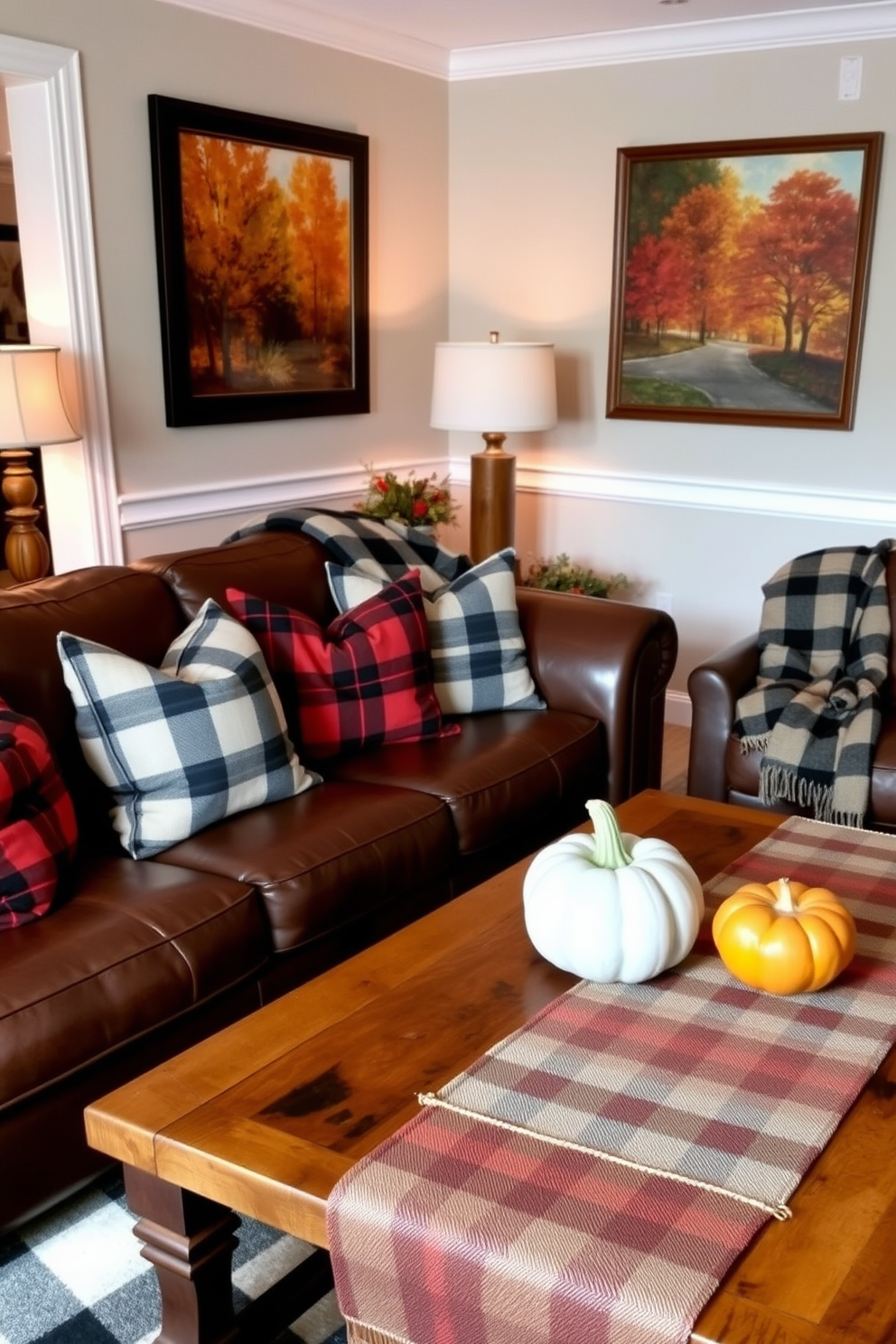 A cozy living room adorned with plaid patterns in textiles and decor. Soft plaid throw pillows are arranged on a deep brown leather sofa, while a matching plaid blanket drapes over the armrest. The coffee table features a rustic wooden surface, topped with a small pumpkin centerpiece and a plaid table runner. Warm autumn hues are reflected in the artwork hanging on the walls, enhancing the seasonal atmosphere.