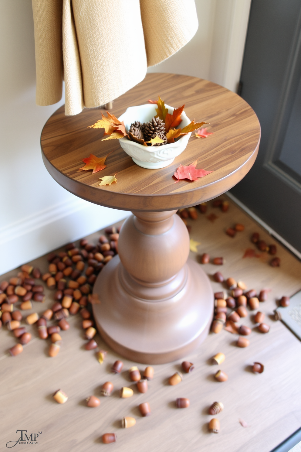 A charming entryway table adorned with scattered acorns creates a warm autumn ambiance. The table features a rustic wooden surface complemented by a small decorative bowl filled with seasonal leaves and pinecones.