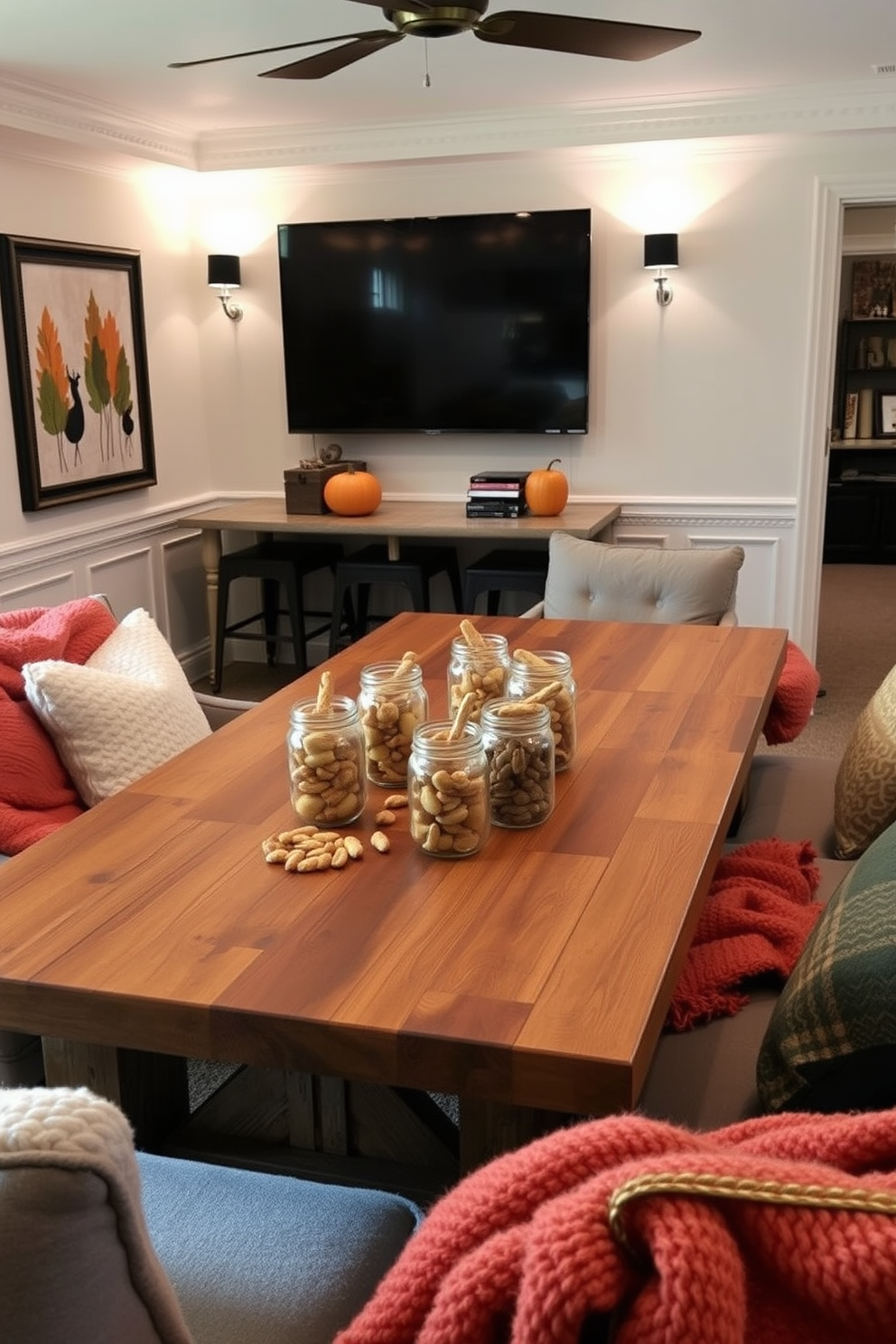 A cozy cider bar setup for game nights features a rustic wooden countertop adorned with several glass jars filled with assorted spiced ciders. Surrounding the bar are high-backed stools upholstered in warm plaid fabric, inviting friends to gather and enjoy. The fall game room is decorated with rich autumn colors, including deep oranges and browns, complemented by soft lighting from vintage-style pendant lamps. Plush area rugs with leaf patterns cover the hardwood floor, providing a comfortable space for players to relax and enjoy their favorite games.