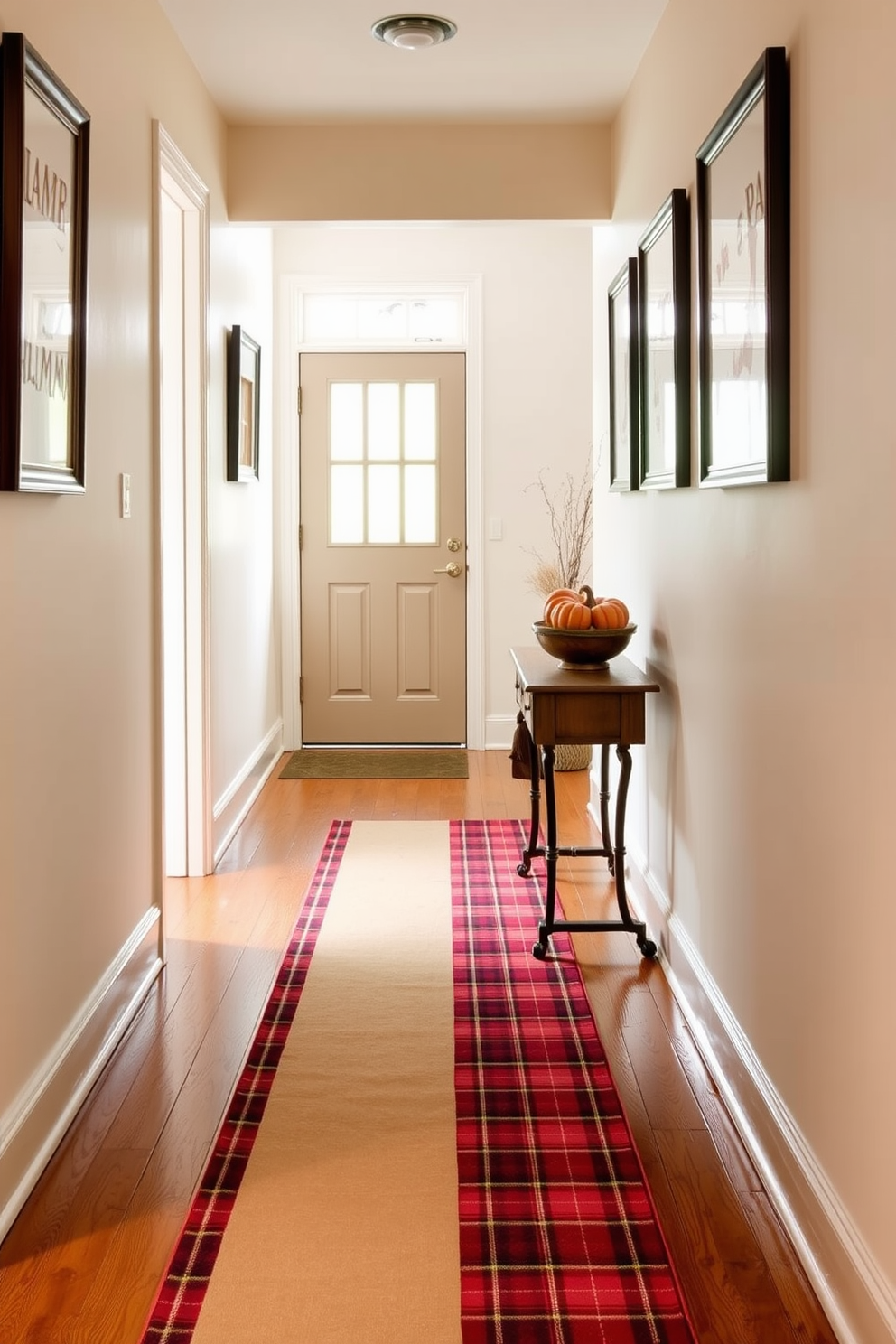 A warm plaid runner stretches across the wooden floor of a cozy hallway. The walls are adorned with framed autumn-themed artwork, and a small console table holds a decorative bowl filled with seasonal gourds.