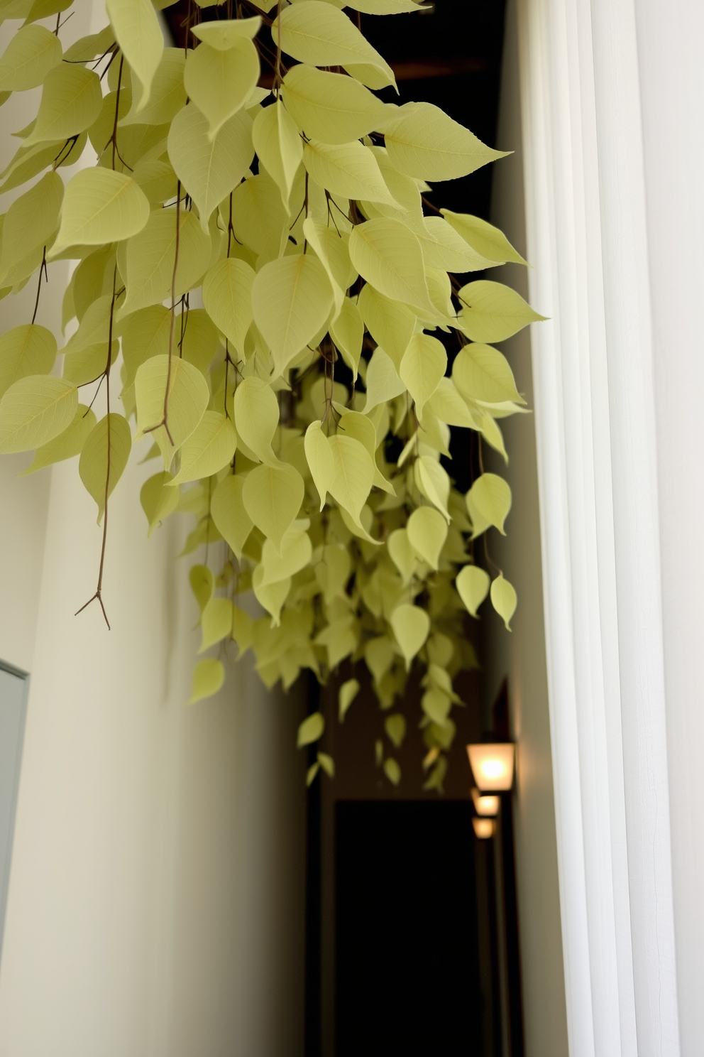 A serene hallway adorned with hanging fabric leaves gracefully cascading from the ceiling. Soft, diffused lighting highlights the delicate textures of the leaves, creating an inviting atmosphere.