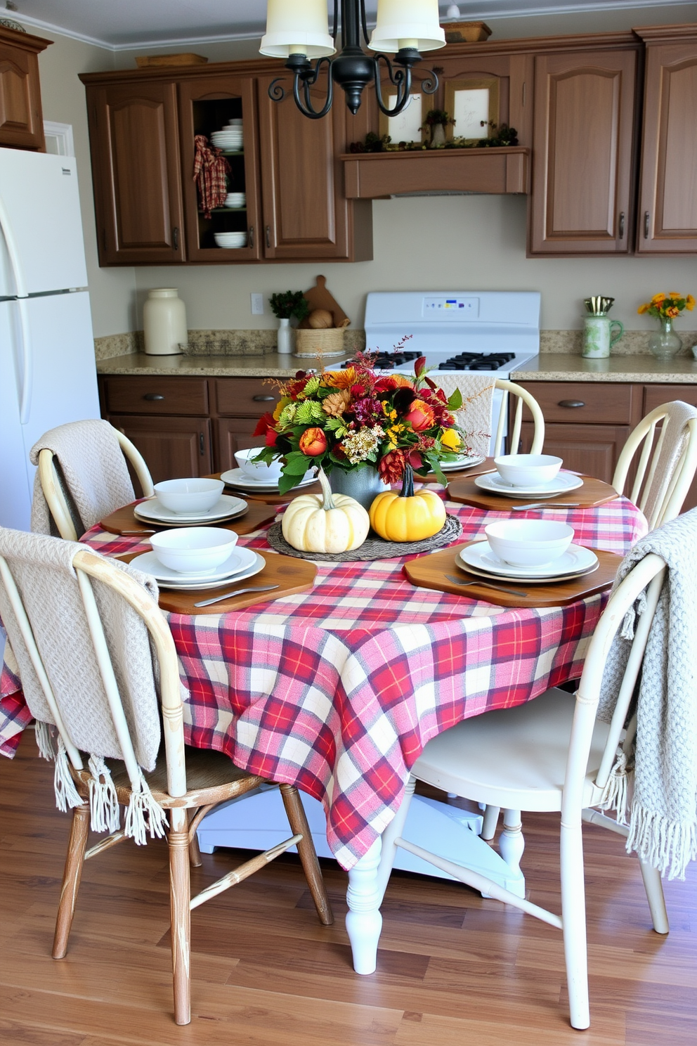 A cozy kitchen adorned with colorful fall leaves scattered across the countertops and dining table. The warm hues of orange, red, and yellow create a vibrant atmosphere, complementing the rustic wooden cabinetry and soft lighting.