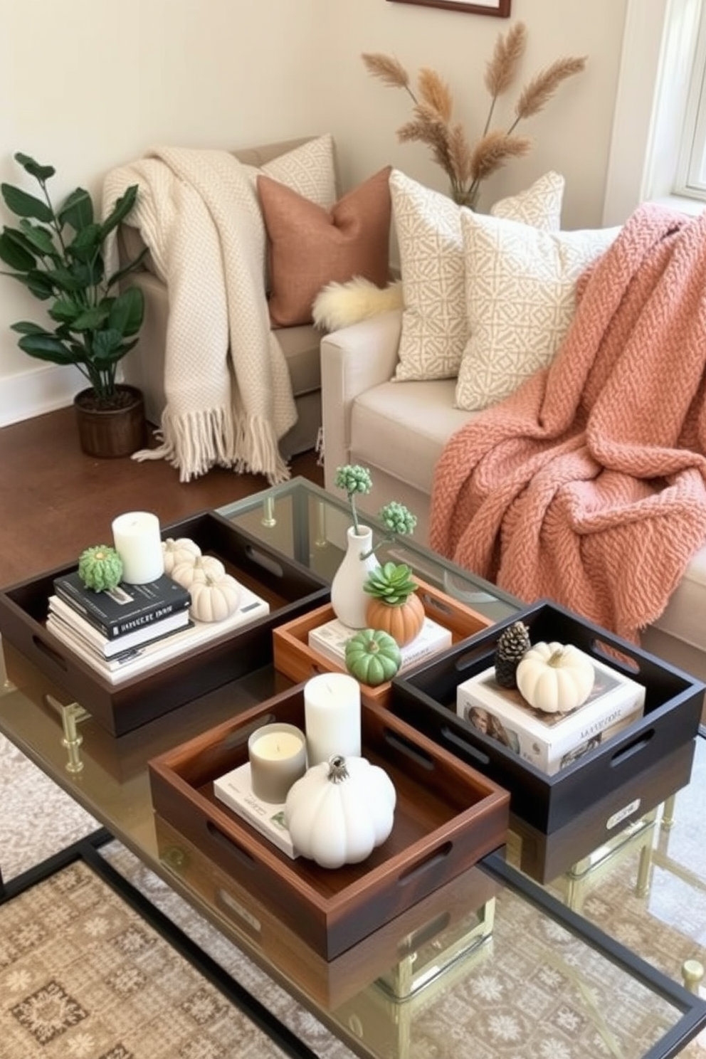 A collection of decorative trays in various sizes and materials arranged on a stylish coffee table. Each tray holds a curated selection of items such as candles, books, and small plants, adding both functionality and aesthetic appeal. Cozy fall decorations are incorporated into a small living space with warm tones and natural elements. Plush throw blankets and seasonal accents like pumpkins and pinecones create an inviting atmosphere without overwhelming the limited area.