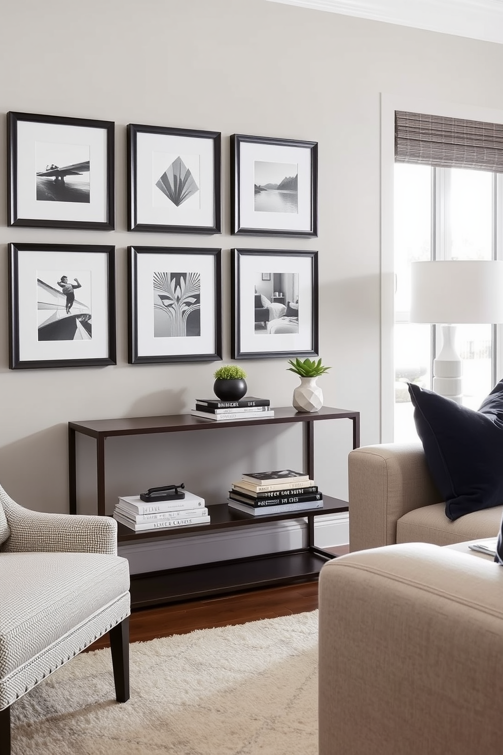 A stylish family room featuring a sleek console table against a wall adorned with framed artwork. The console table is topped with decorative books and a small potted plant, while a plush sectional sofa invites relaxation in the cozy space.