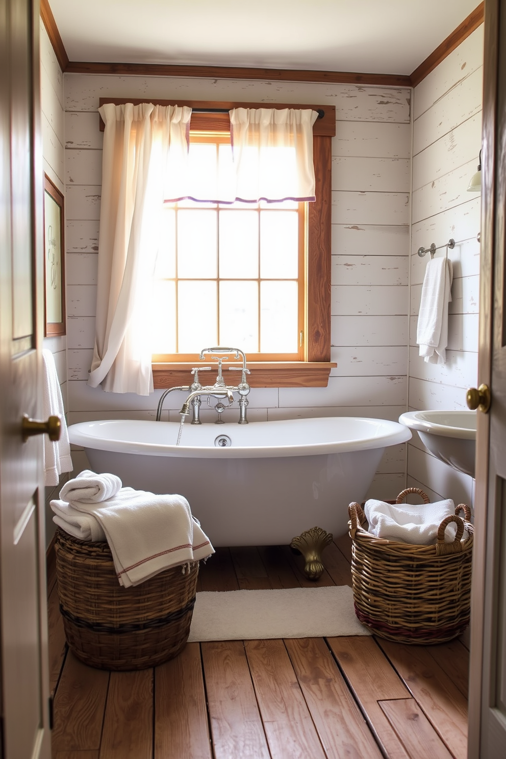 A vintage clawfoot tub sits gracefully in the center of the room, exuding classic elegance. The walls are adorned with shiplap, and rustic wooden shelves display neatly rolled towels and vintage decor. Natural light streams in through a large window, illuminating the space with a warm glow. A woven basket filled with bath essentials rests beside the tub, enhancing the cozy farmhouse atmosphere.