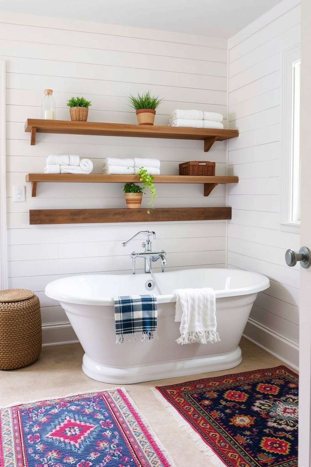 A charming farmhouse bathroom featuring a freestanding soaking tub surrounded by colorful patterned rugs that add texture to the space. The walls are clad in shiplap with a soft white finish, and rustic wooden shelves display neatly rolled towels and decorative plants.