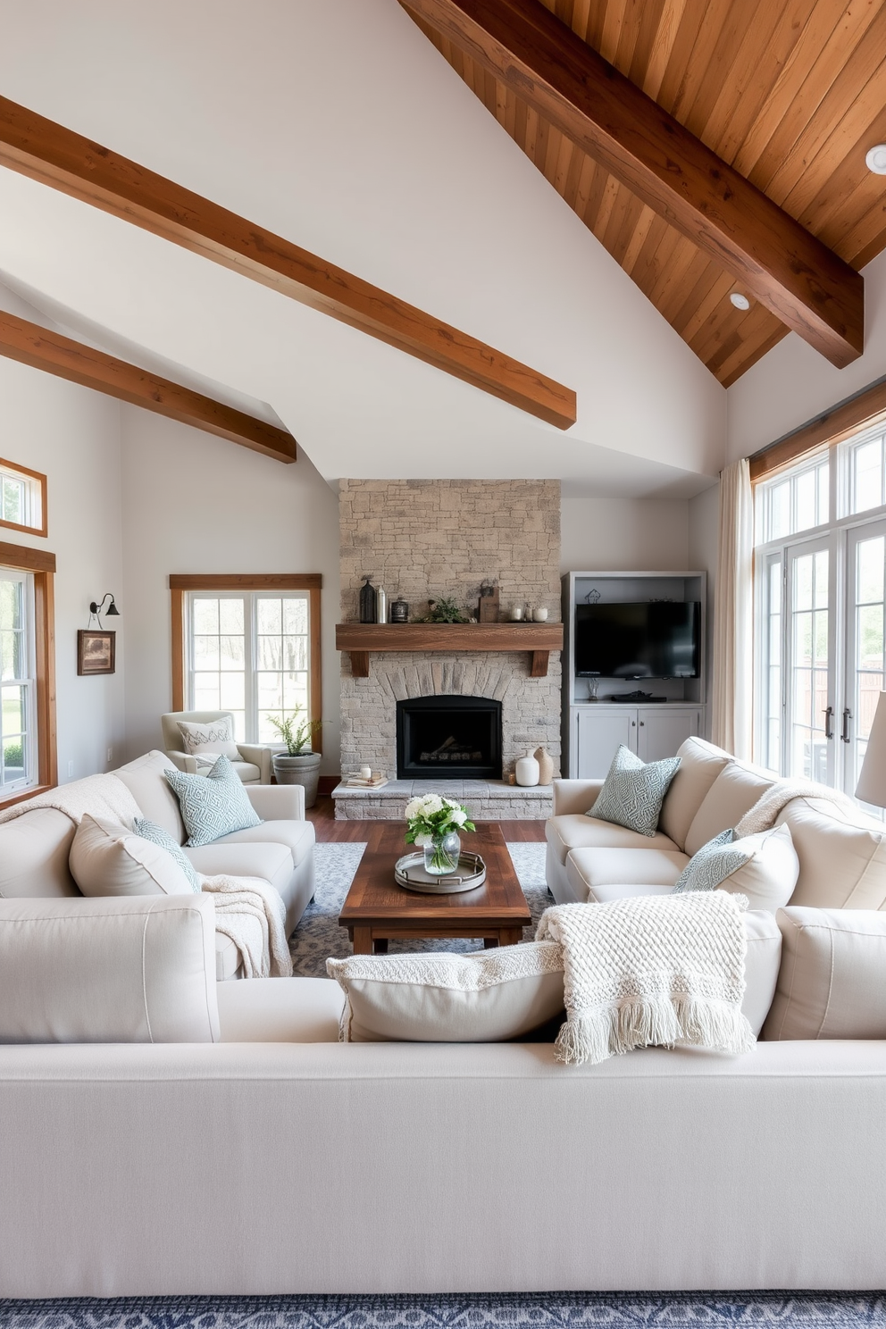 A cozy farmhouse living room featuring a large sectional sofa adorned with comfortable throw blankets in soft, neutral tones. The space is illuminated by natural light streaming through large windows, complemented by rustic wooden beams and a stone fireplace.