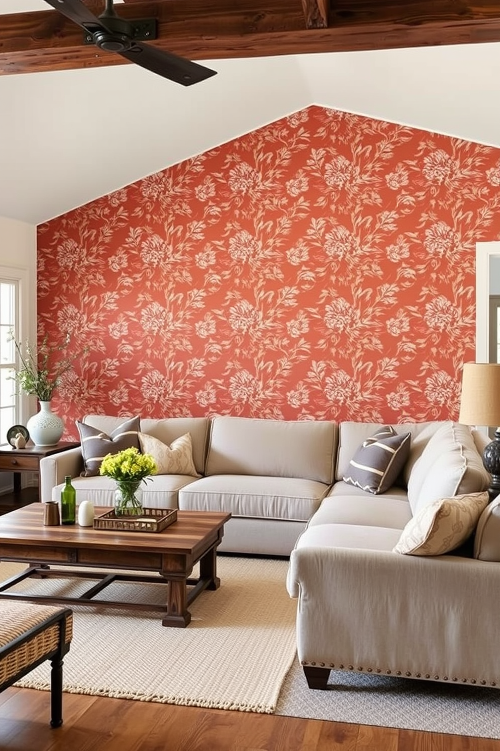 A cozy farmhouse living room featuring a bold accent wall adorned with intricate floral wallpaper. The space includes a large, comfortable sectional sofa in a neutral tone, complemented by rustic wooden coffee tables and vintage decor accents.