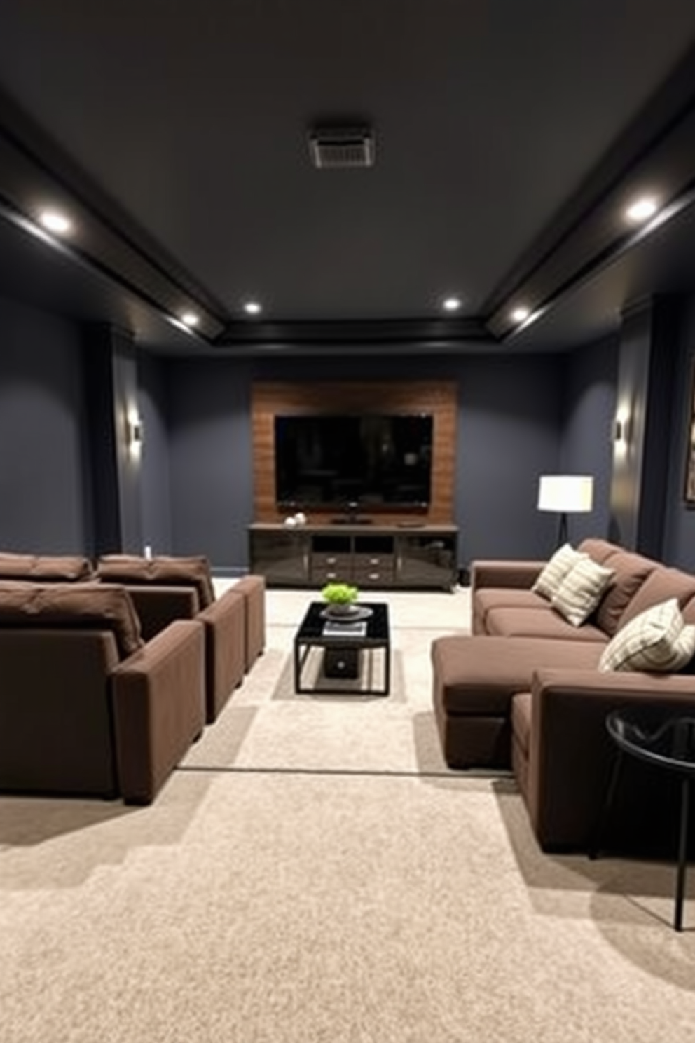 A contemporary media room featuring plush seating arranged for optimal viewing. The walls are painted in a deep navy color, and a large flat-screen TV is mounted above a sleek entertainment unit. The finished basement design includes a cozy lounge area with a sectional sofa and a stylish coffee table. Soft ambient lighting highlights the space, creating a warm and inviting atmosphere.