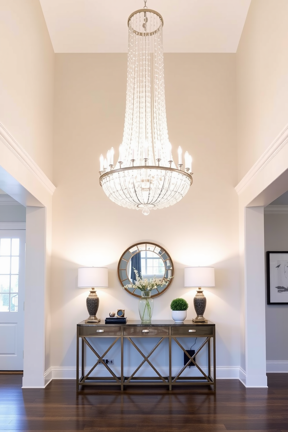 A bright and inviting foyer featuring a stunning statement chandelier that cascades light throughout the space. The walls are adorned with soft neutral tones, complemented by a stylish console table that showcases decorative accents.