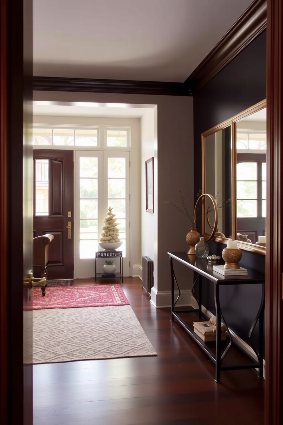 A welcoming foyer with unique door hardware that adds character and charm. The space features a stylish console table adorned with decorative objects and a large wall mirror reflecting natural light.