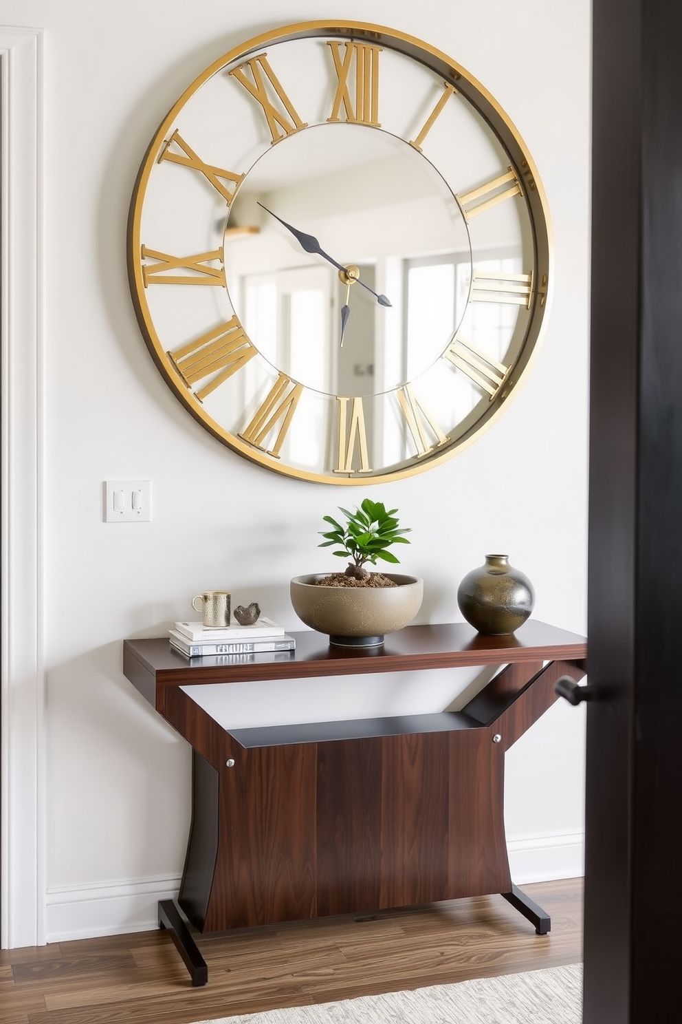 A welcoming foyer featuring a sleek console table made of dark wood, topped with a stylish decorative bowl and a small potted plant. On the wall above the table, a large round statement clock with a brass finish adds both functionality and elegance to the space.