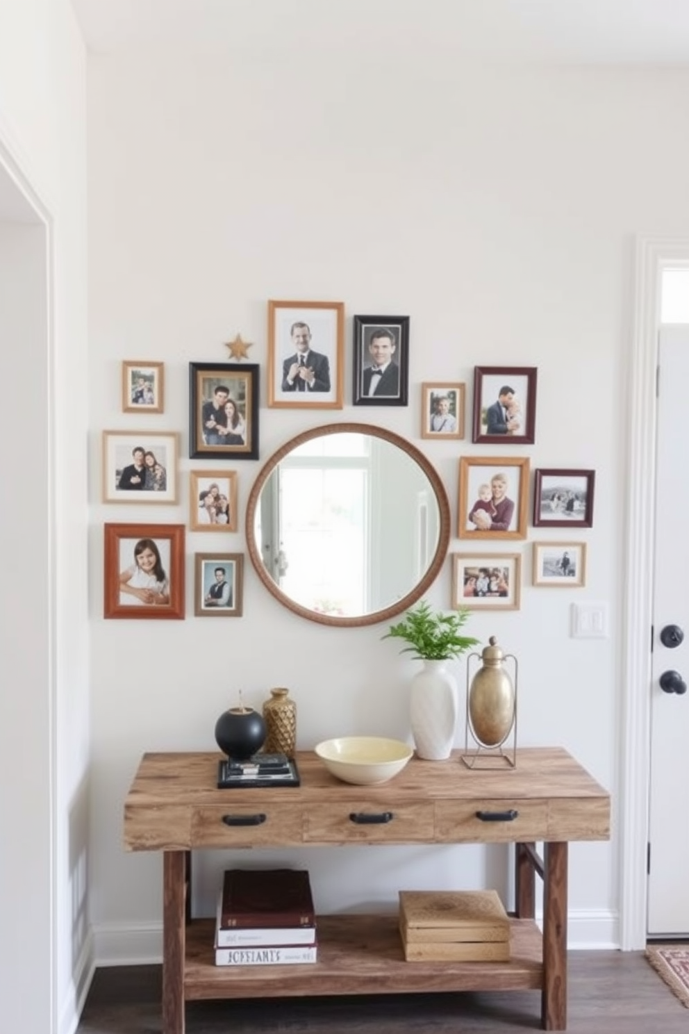 A gallery wall of family photos showcasing a mix of framed pictures in various sizes and styles. The wall is painted in a soft white hue to enhance the visual impact of the photographs. The foyer features a stylish console table made of reclaimed wood with decorative items on top. A large round mirror hangs above the table, reflecting natural light from a nearby window.