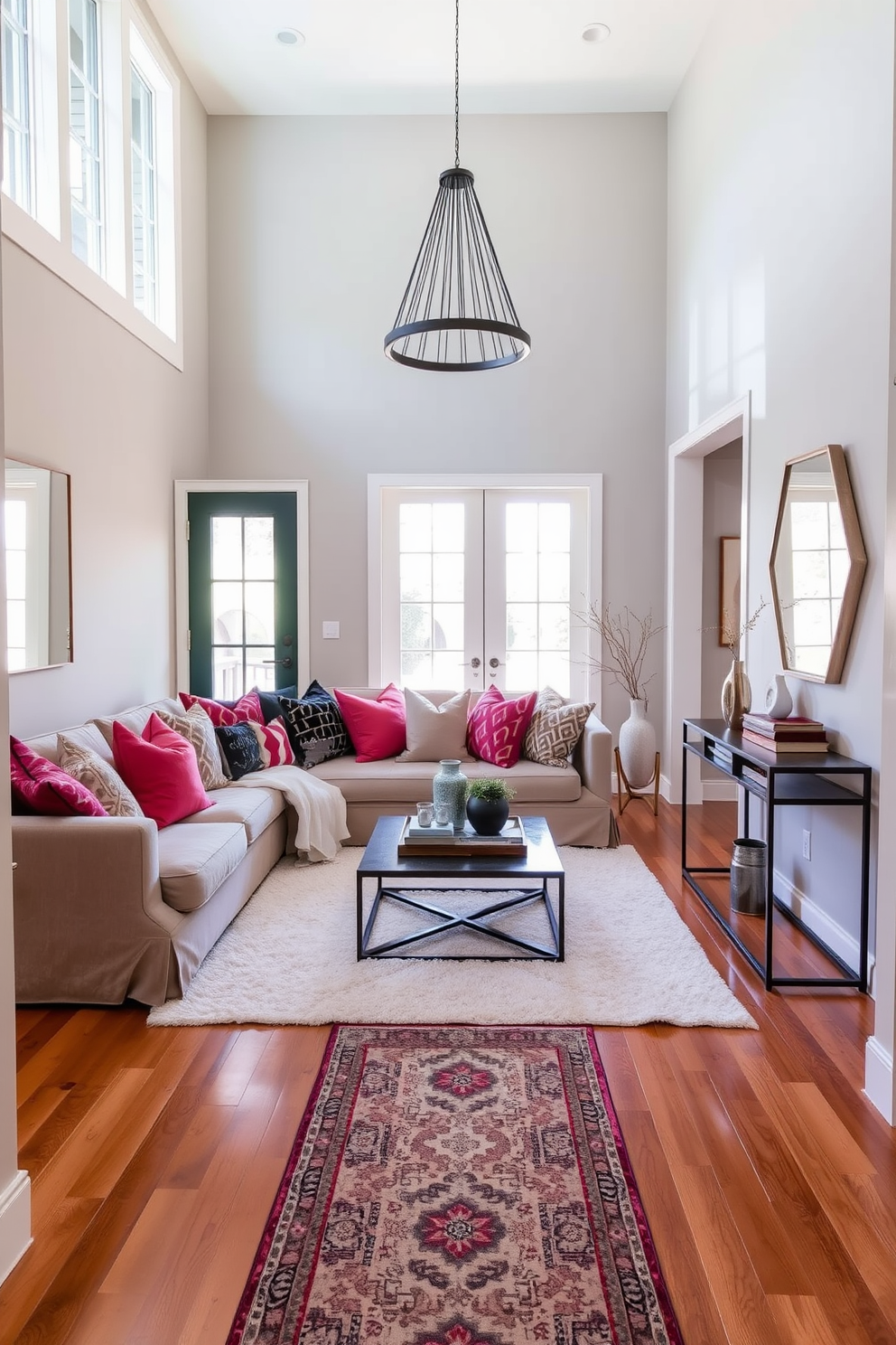 Cozy seating area with throw pillows. A plush sofa is adorned with an array of colorful throw pillows, creating an inviting atmosphere. A soft area rug lies underneath, complementing the warm wooden flooring. Natural light pours in through large windows, illuminating the space and highlighting a small coffee table in front of the sofa. Foyer entryway design ideas. The entryway features a sleek console table against the wall, topped with decorative items and a stylish mirror. A statement pendant light hangs from the ceiling, while a patterned runner rug leads to the living space, welcoming guests into the home.