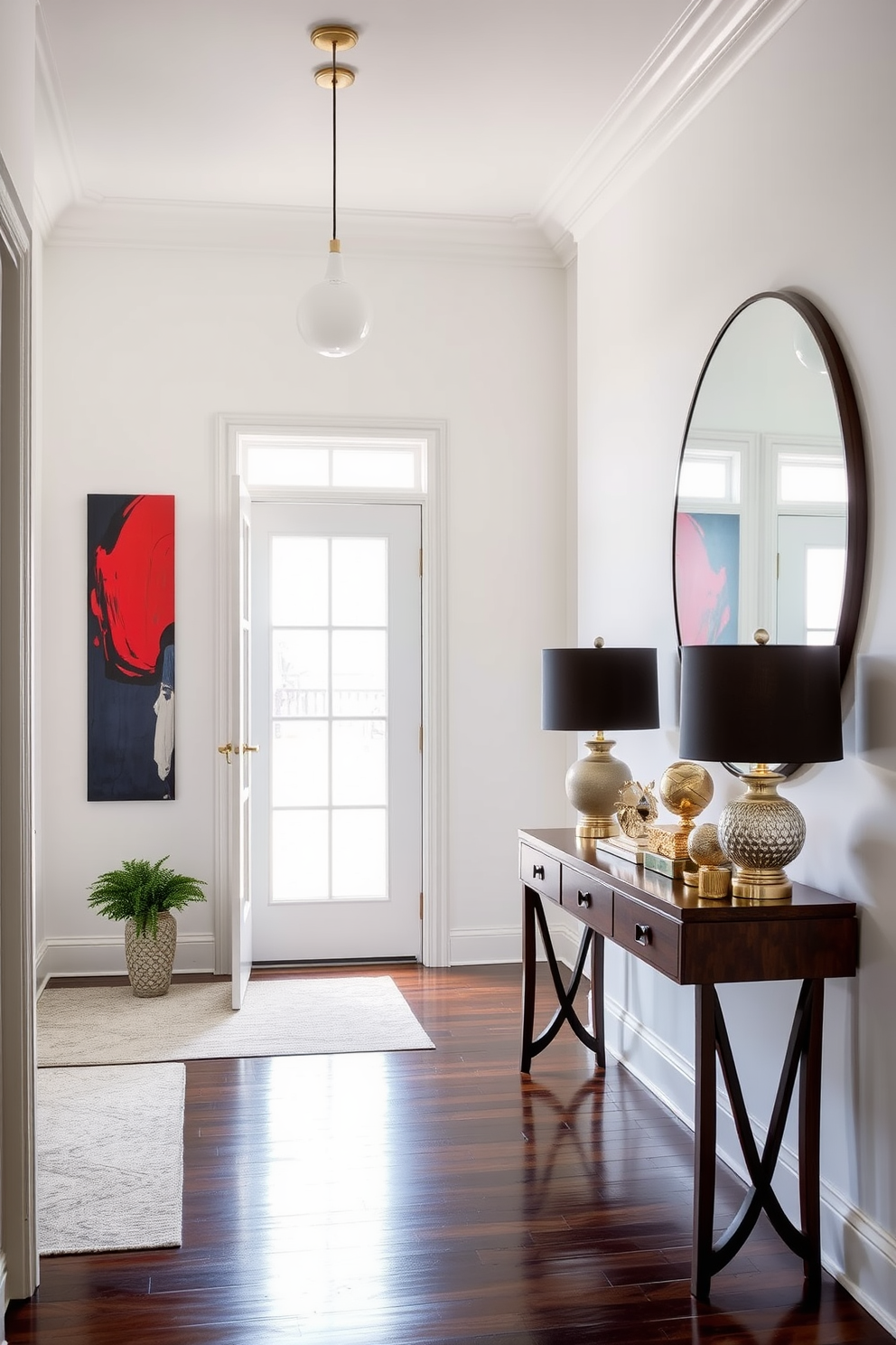 A striking foyer entryway featuring bold artwork as a focal point. The walls are painted in a crisp white, allowing the vibrant colors of the artwork to stand out beautifully. A console table made of dark wood sits against the wall, adorned with decorative objects and a stylish lamp. A large round mirror hangs above the table, reflecting the natural light that floods in from a nearby window.