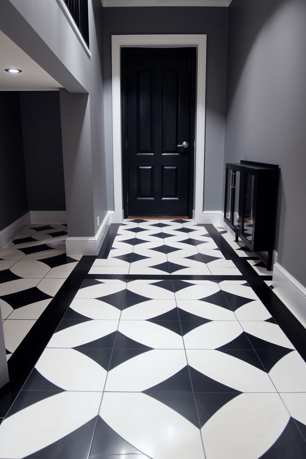 A modern foyer features geometric patterned tiles in a striking black and white design that draws the eye upon entry. The walls are painted in a soft gray hue, creating a balanced contrast that enhances the contemporary aesthetic.