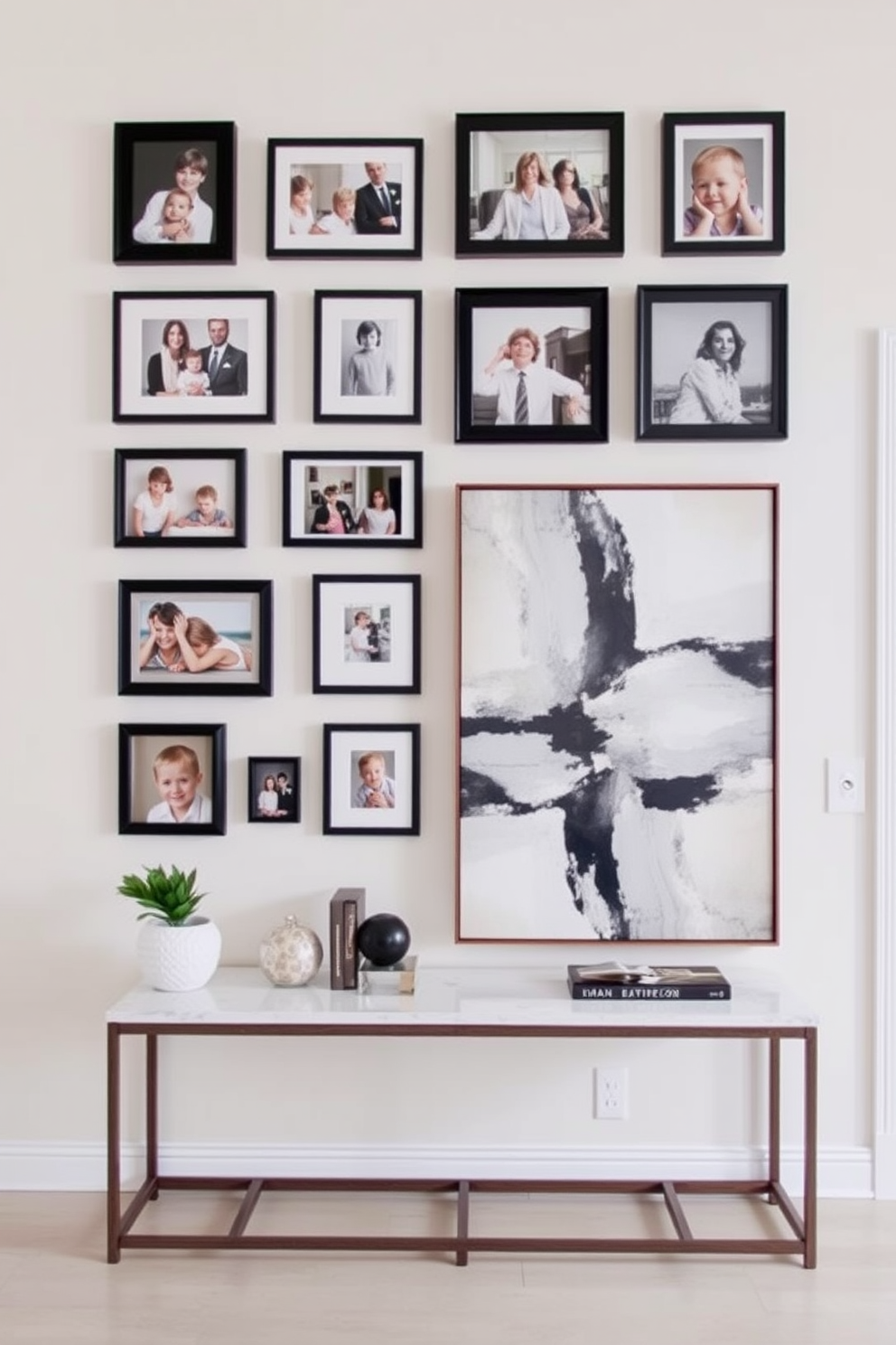 A gallery wall featuring a curated collection of family photos in various sizes and frames. The arrangement is balanced and visually appealing, showcasing cherished memories against a soft neutral backdrop. For the foyer wall design, envision a statement piece such as a large abstract painting that draws the eye. Complement the artwork with a slim console table topped with decorative accents and a stylish mirror above it.