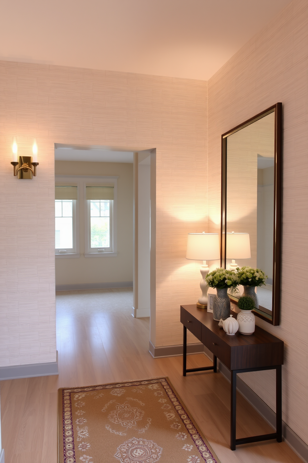 A welcoming foyer featuring a statement wall design with textured wallpaper in soft neutral tones. Elegant wall sconces flank the entrance, casting a warm glow that enhances the inviting atmosphere. The floor is adorned with a stylish runner that complements the wall design, leading guests into the home. A console table against the wall showcases decorative items and a large mirror that reflects the ambient lighting, creating a sense of space.