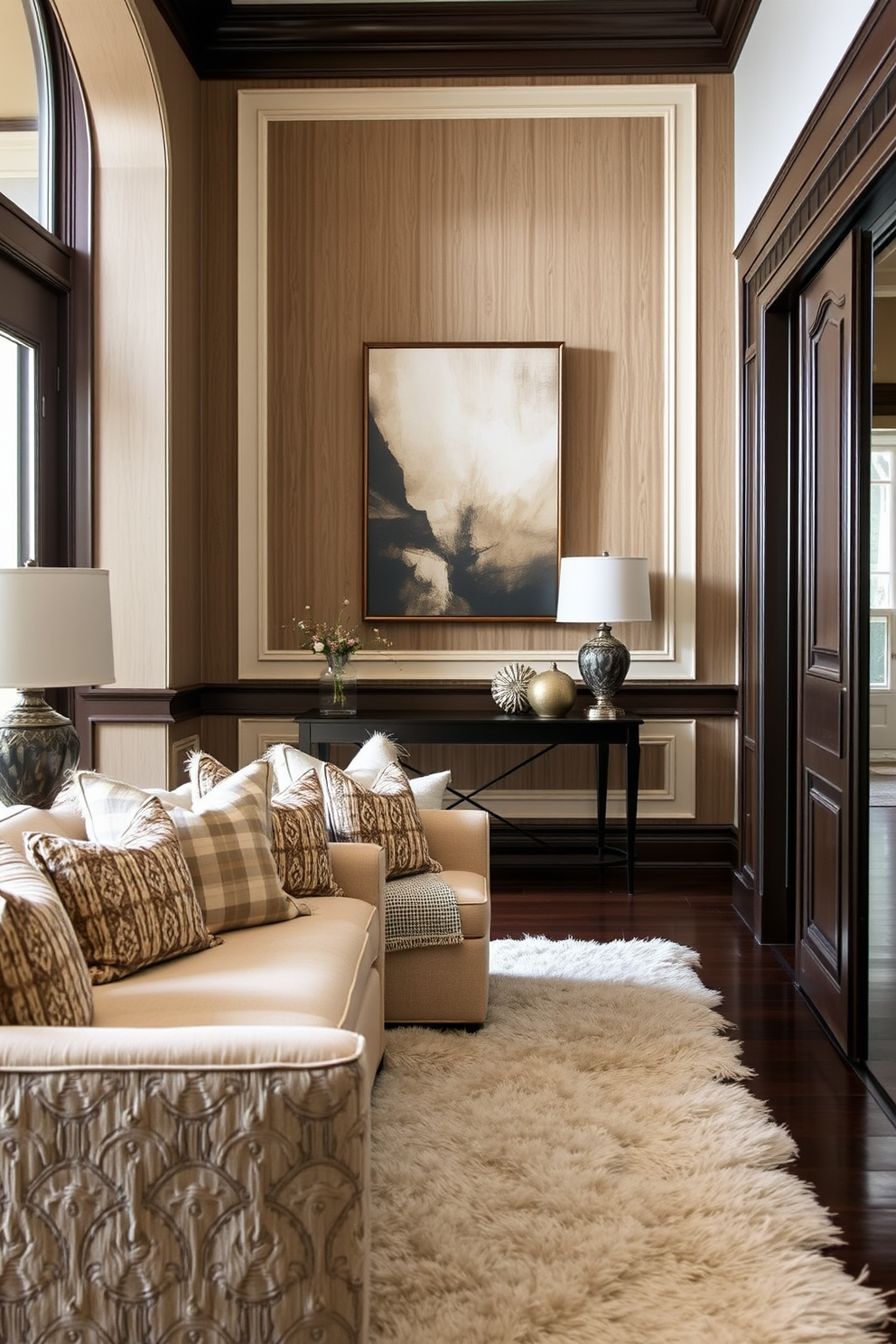 Layered textiles create a warm and inviting atmosphere in the foyer. Soft throw pillows and a plush area rug complement the elegant seating arrangement, enhancing the comfort of the space. The foyer wall features a striking design with a combination of textured panels and decorative molding. A statement piece of art hangs prominently, drawing attention and setting the tone for the rest of the home.