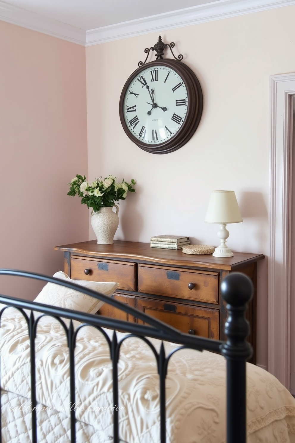 A charming French country bedroom features an antique clock as a focal point above a rustic wooden dresser. Soft pastel colors adorn the walls, and a cozy quilt drapes over a wrought iron bed with plump pillows.