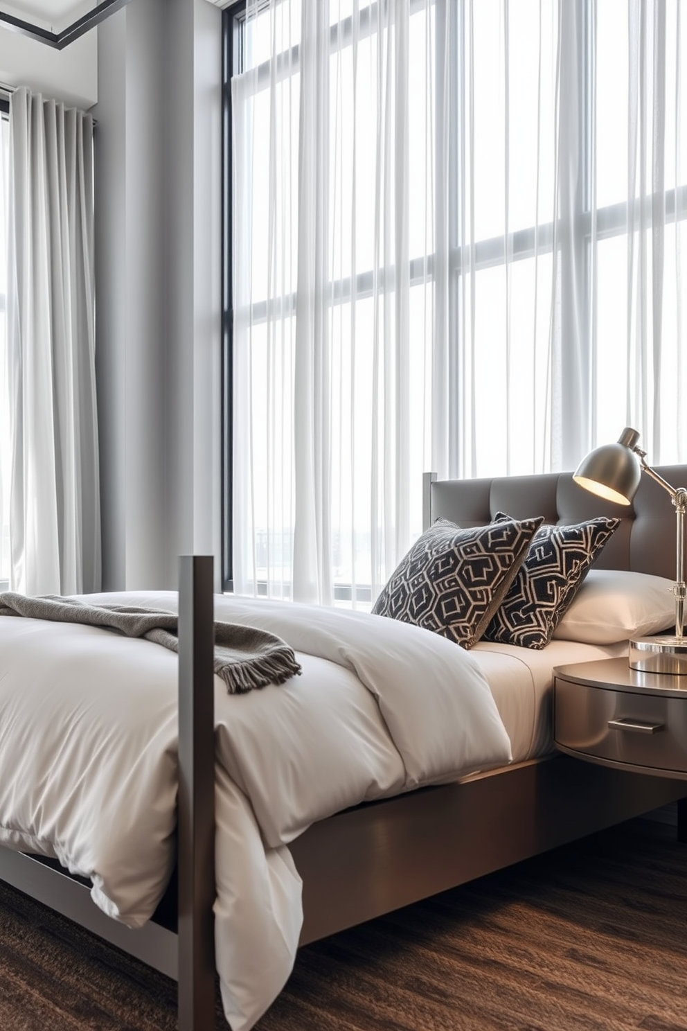 A modern urban chic bedroom featuring sleek lines and metal accents. The bed is framed in brushed steel with crisp white bedding and a geometric patterned throw. On one side of the bed, a minimalist nightstand holds a stylish lamp with a metallic finish. Large windows with sheer curtains allow natural light to flood the space, highlighting the industrial-style decor.