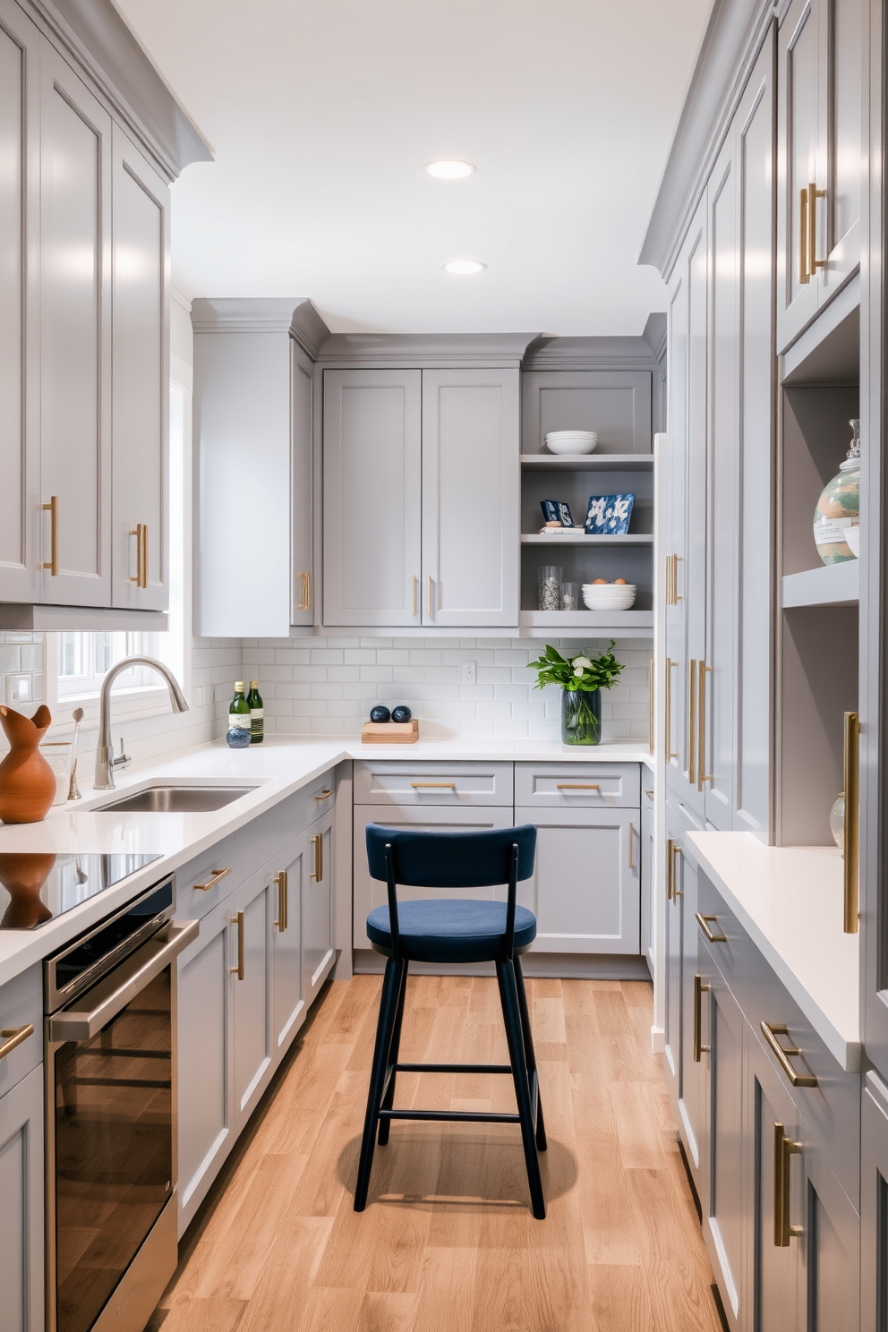 A galley kitchen designed with a cohesive color palette featuring soft gray cabinets and white countertops. Accents of navy blue are incorporated through bar stools and decorative items, creating a modern yet inviting atmosphere.