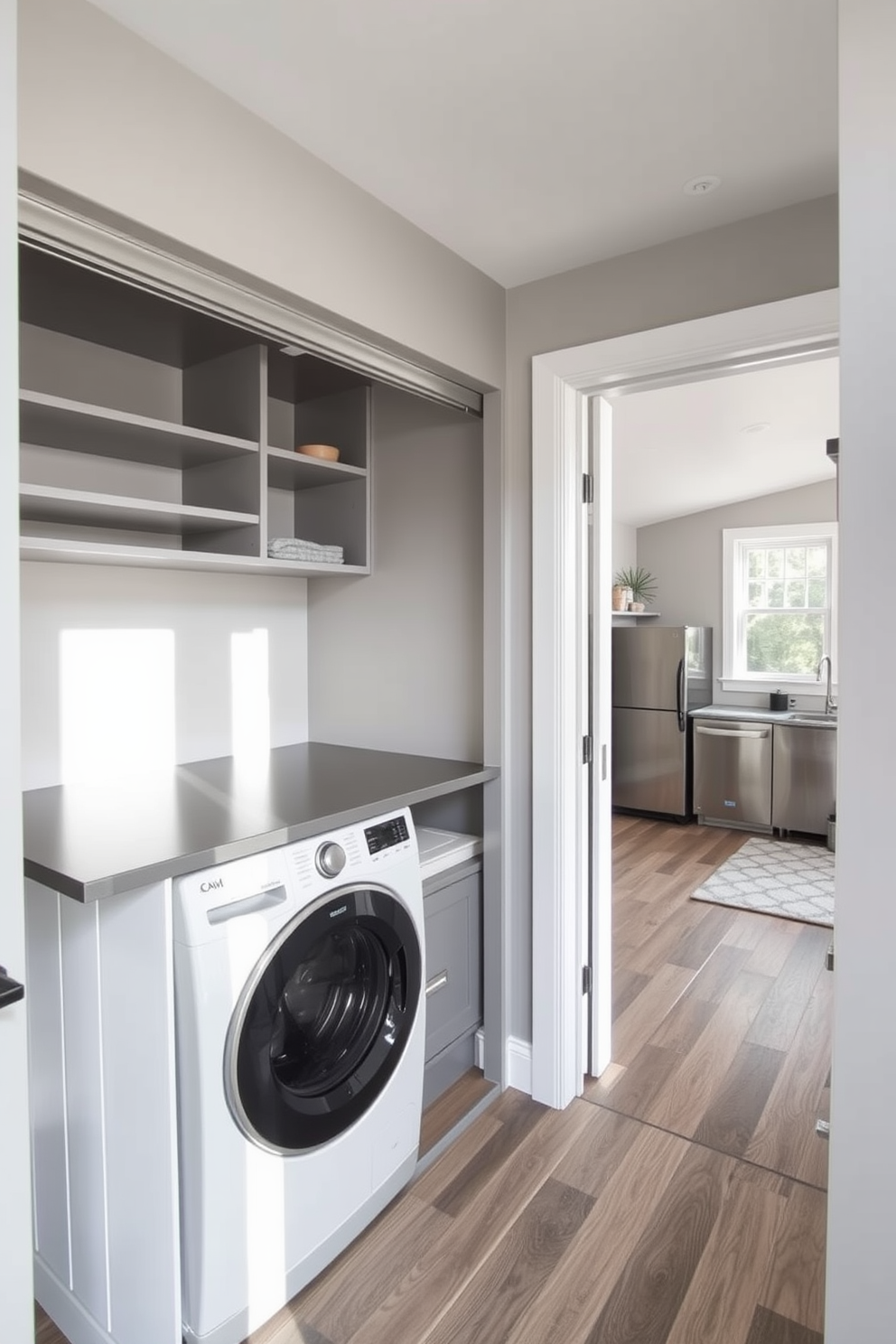 A functional laundry area is integrated into a spacious closet featuring built-in shelving and a sleek countertop for folding clothes. The walls are painted in a soft gray color, and the floor is adorned with durable vinyl planks for easy maintenance. In the garage apartment, an open layout maximizes space with a cozy living area that transitions seamlessly into a compact kitchen. Large windows allow natural light to flood the room, highlighting the modern appliances and minimalist decor.