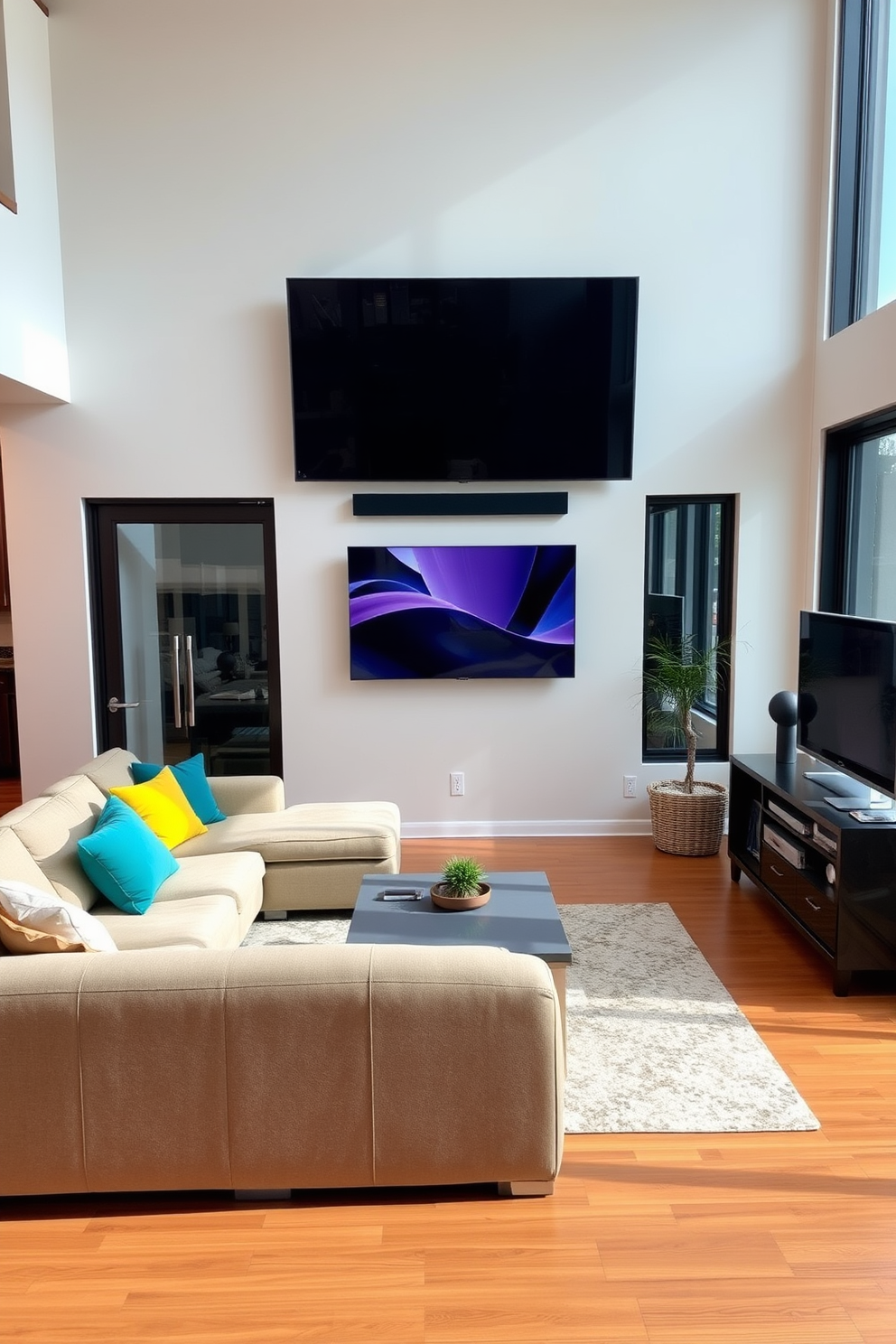 A contemporary living room featuring a wall-mounted TV as the focal point. The space includes a plush sectional sofa in a neutral tone, accented by colorful throw pillows and a sleek coffee table in front. To the side, a stylish media console holds additional entertainment equipment and decorative items. Large windows allow natural light to flood the room, highlighting the warm wood flooring and inviting atmosphere.