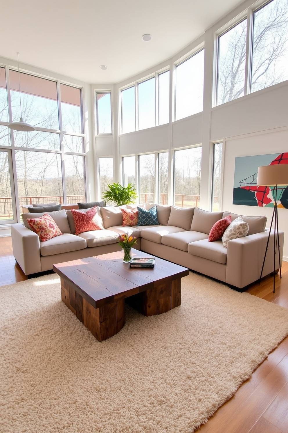 Bright open spaces with large windows create a welcoming atmosphere filled with natural light. The room features a comfortable sectional sofa in neutral tones, accented by colorful throw pillows and a sleek coffee table made of reclaimed wood. The walls are adorned with contemporary artwork that adds a pop of color, while a soft area rug anchors the seating area. A stylish floor lamp stands in the corner, providing additional lighting and enhancing the cozy feel of the space.