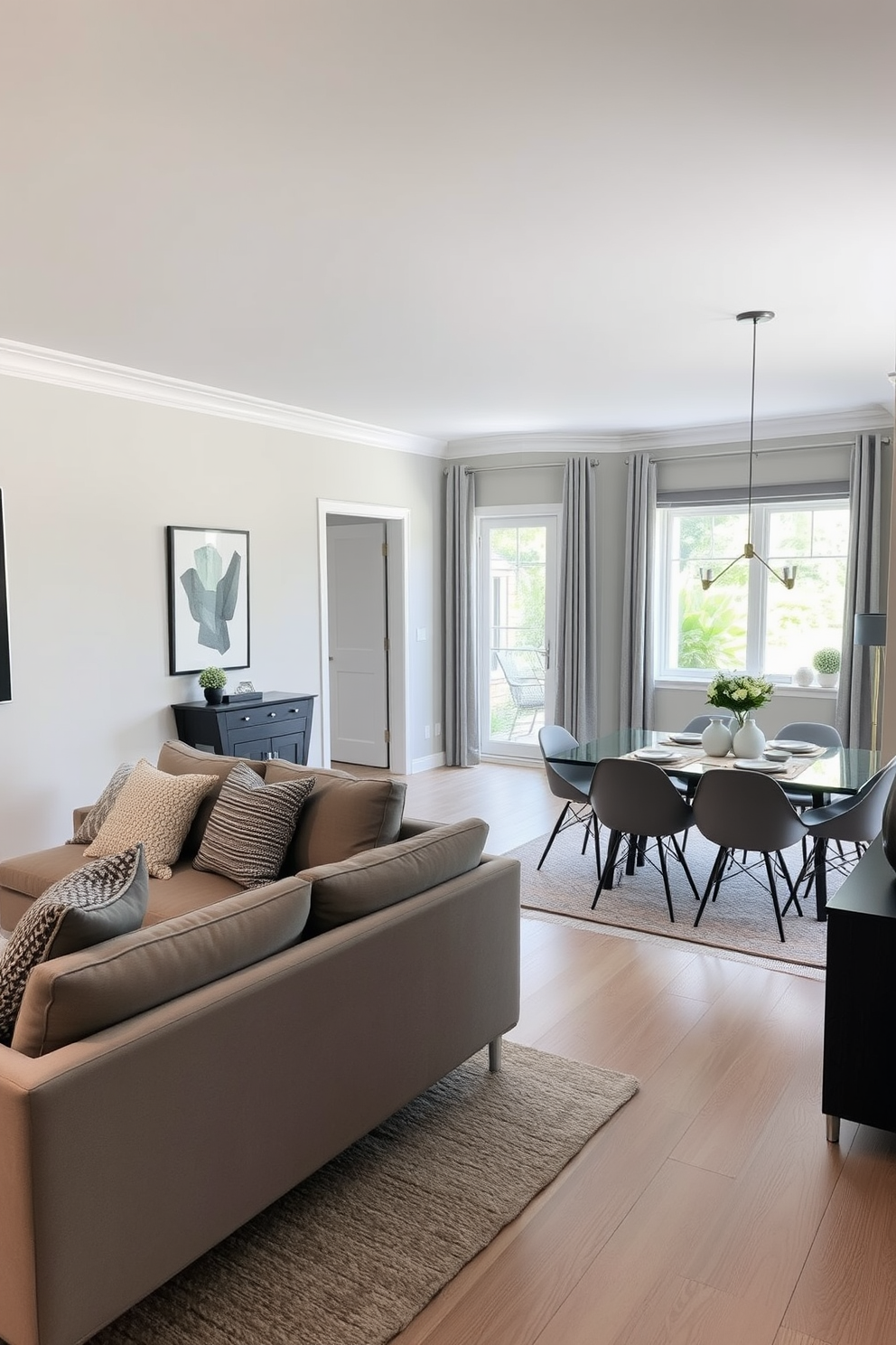 A stylish open concept living and dining area featuring a soft gray color palette. The space includes a plush sectional sofa adorned with textured throw pillows and a sleek dining table set for six with modern chairs.