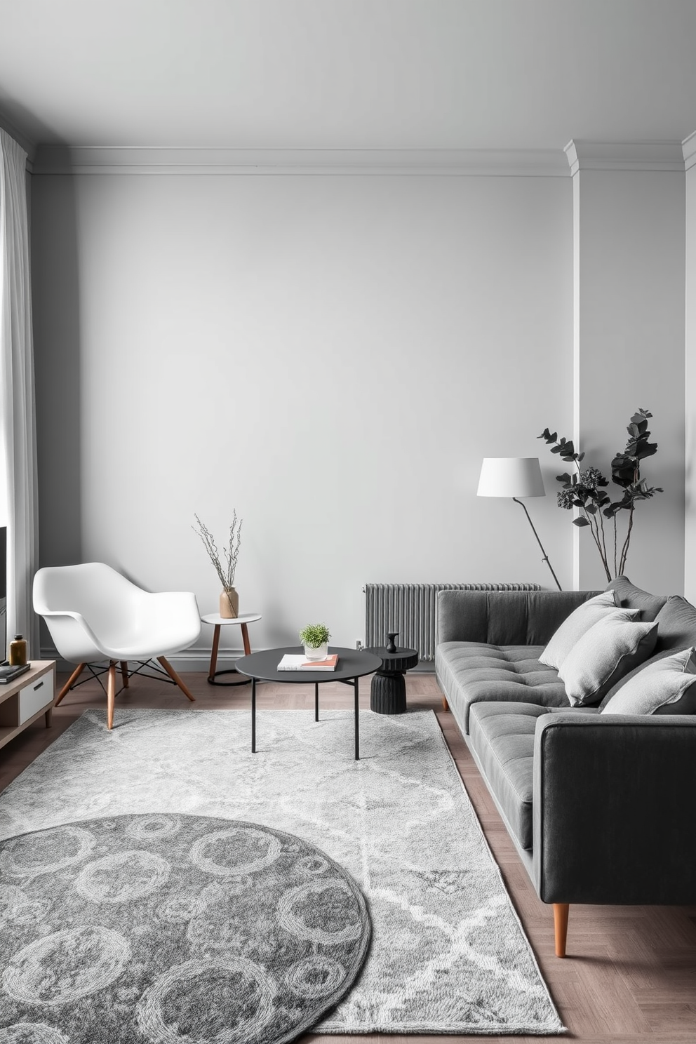 A chic apartment living space featuring layered gray rugs that add depth and texture to the room. The walls are painted in a soft gray tone, complemented by modern furniture in varying shades of gray and white.