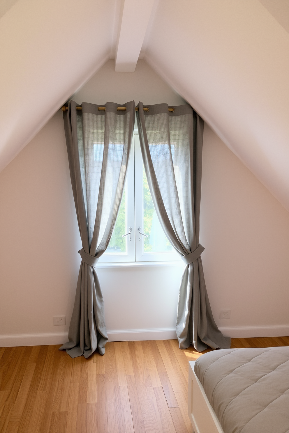 A cozy attic room with soft gray curtains gently filtering the light. The walls are painted in a light neutral tone, and the floor features warm wooden planks.