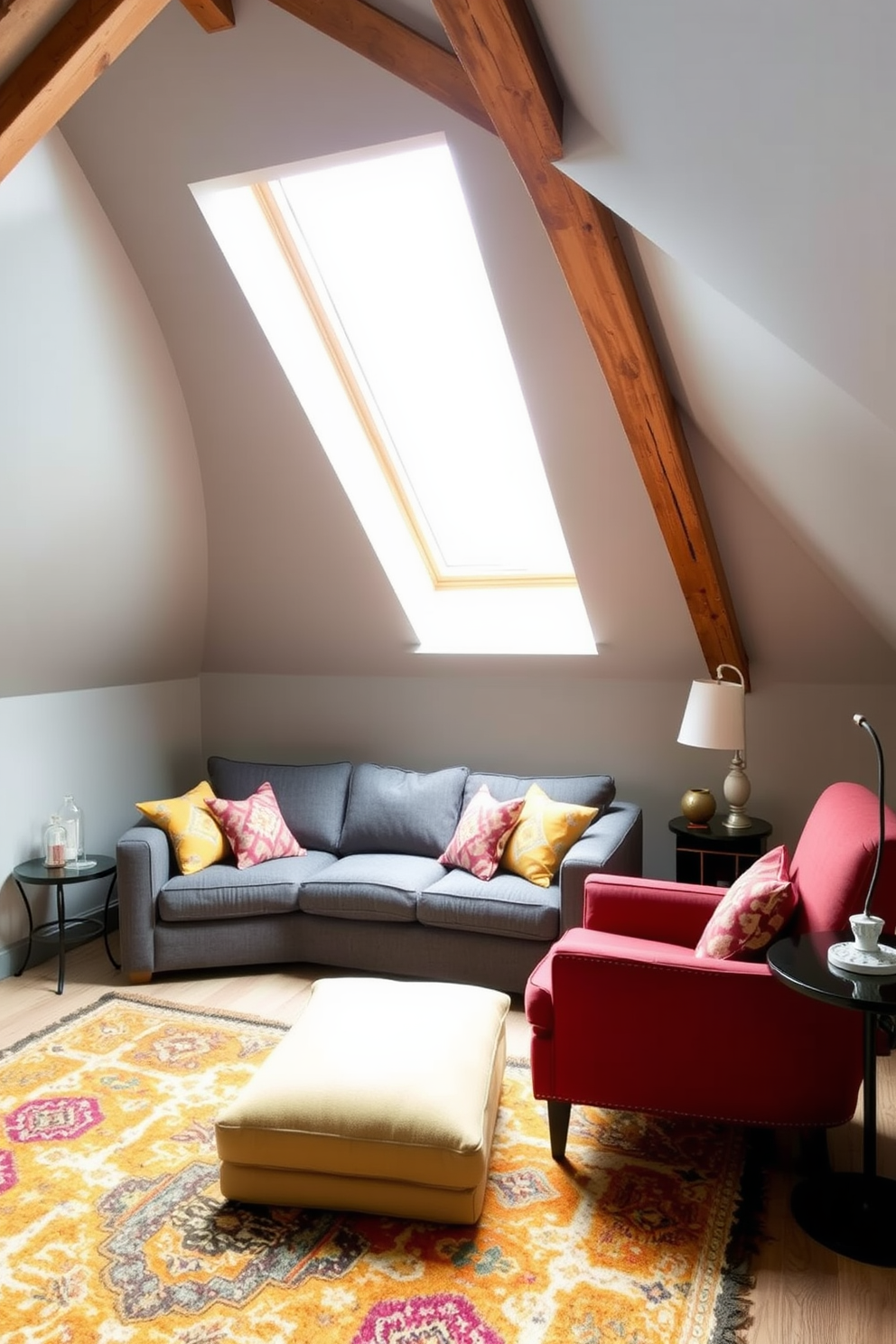 A cozy gray attic room features a sloped ceiling with exposed wooden beams that add character and warmth. The walls are painted a soft gray, creating a serene backdrop for the bold printed accent pillows scattered across a plush gray sofa. Natural light streams in through a large skylight, illuminating a stylish reading nook with a comfortable armchair and a small side table. A vibrant area rug anchors the space, complementing the overall design while adding a touch of color and texture.