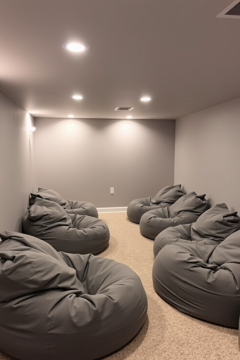 A cozy gray basement designed for relaxation features soft gray bean bags arranged in a casual seating area. The walls are painted in a warm gray tone, complemented by ambient lighting that creates a welcoming atmosphere.