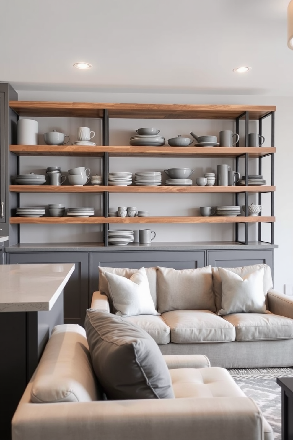 Open shelving displays a curated collection of gray kitchenware, creating a modern and minimalist aesthetic. The shelves are made of reclaimed wood, adding warmth to the sleek gray tones of the kitchen. The basement features a cozy lounge area with plush seating in neutral tones, complemented by gray accent pillows. Soft lighting fixtures enhance the ambiance, while a stylish area rug anchors the space, making it inviting and functional.