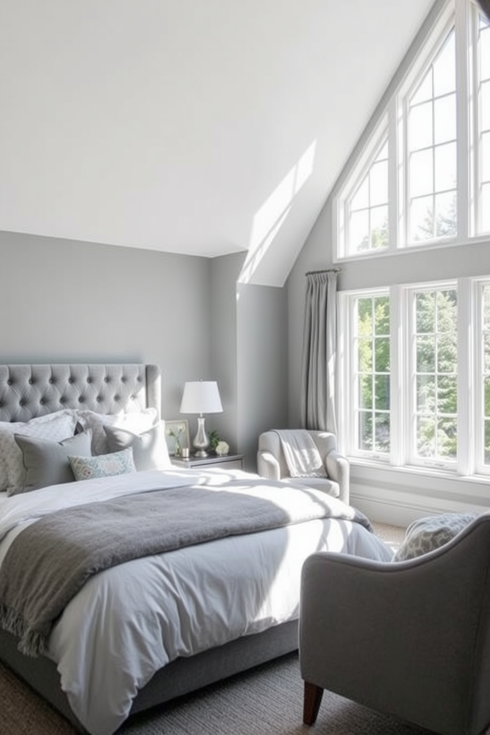 A serene gray bedroom filled with natural light. Soft gray walls create a calming atmosphere, complemented by a plush gray upholstered bed adorned with white and gray bedding. Large windows allow sunlight to stream in, enhancing the airy feel of the space. A cozy reading nook with a soft gray armchair and a small side table sits by the window, inviting relaxation.