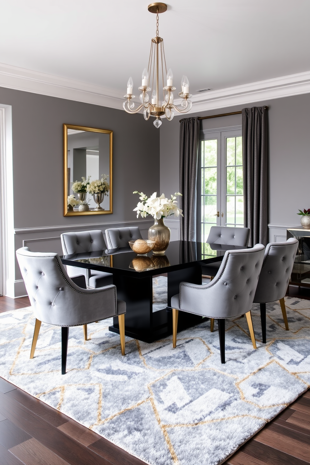 Chic gray velvet chairs with gold accents are arranged around a sleek black dining table. The walls are painted a soft gray, and a modern chandelier hangs above, adding a touch of elegance to the space. The floor is adorned with a plush area rug featuring geometric patterns in shades of gray and gold. Large windows allow natural light to flood the room, enhancing the luxurious atmosphere.