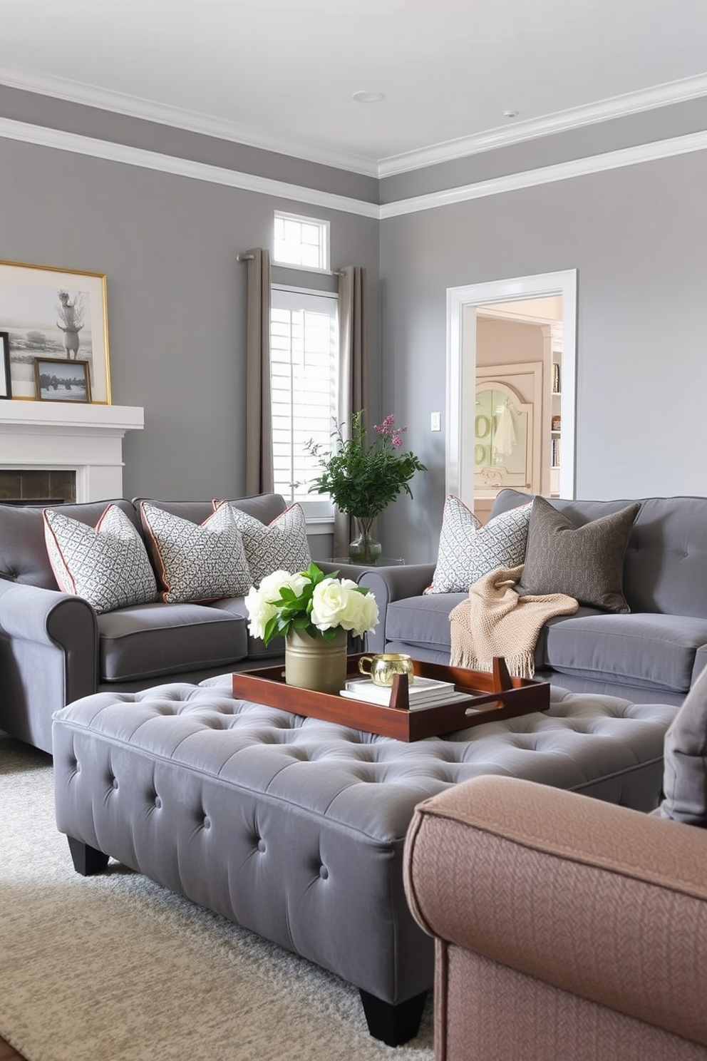 A cozy gray family room features a plush gray upholstered ottoman that provides additional seating and comfort. The space is adorned with soft lighting and warm textiles, creating an inviting atmosphere for family gatherings.