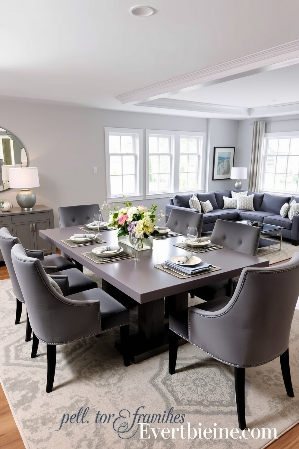 An elegant gray dining table set features a sleek rectangular table surrounded by plush upholstered chairs in a complementary shade. The table is adorned with a tasteful centerpiece of fresh flowers and stylish tableware, creating a sophisticated atmosphere for gatherings. The gray family room design incorporates a comfortable sectional sofa with soft throw pillows and a chic coffee table as the focal point. Large windows allow natural light to flood the space, while a cozy area rug adds warmth and texture to the room.