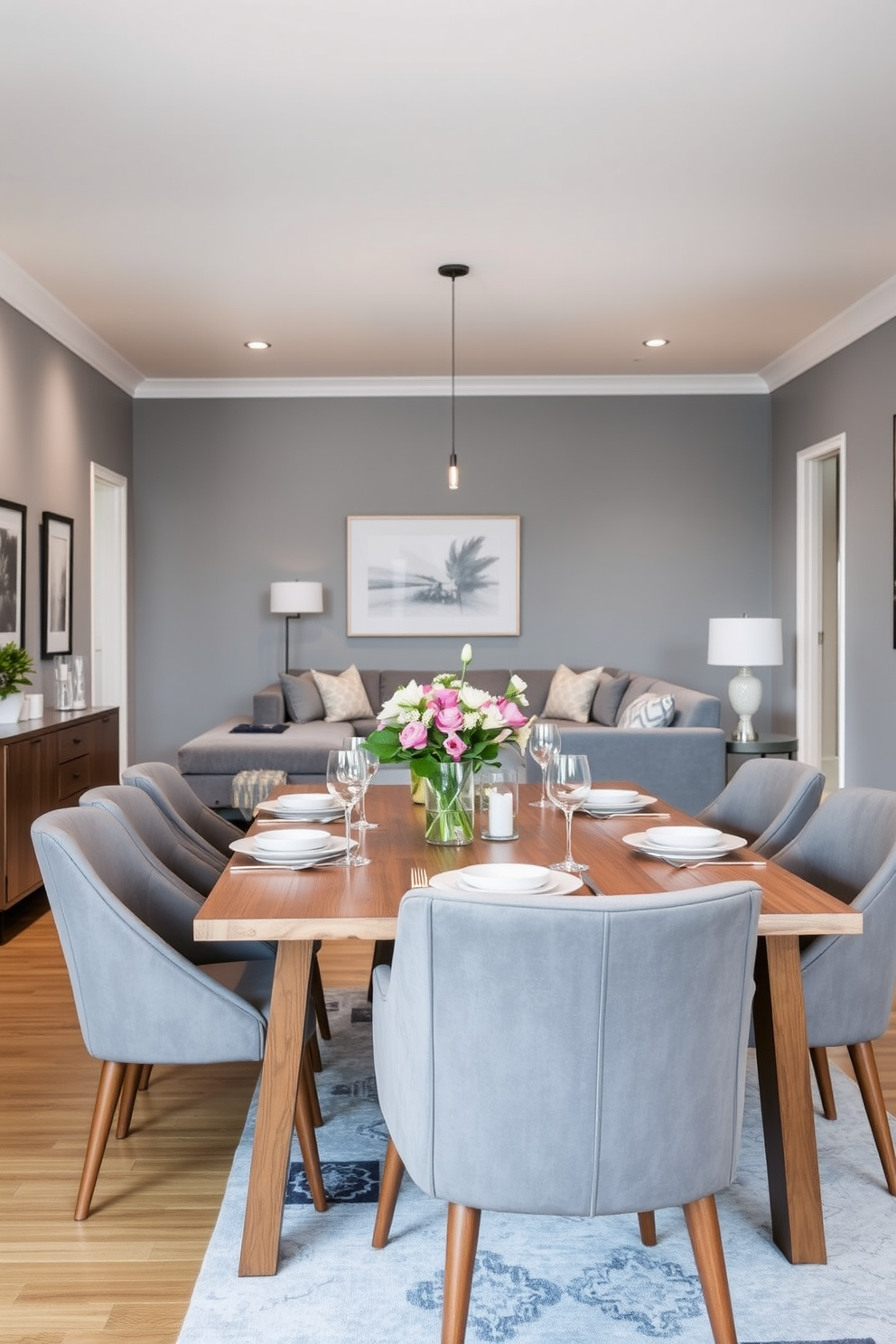 A modern dining room featuring gray dining chairs arranged around a sleek wooden table. The table is set with elegant dinnerware and a centerpiece of fresh flowers. A cozy family room designed with gray tones, showcasing a plush sectional sofa and a stylish coffee table. The walls are adorned with framed artwork, and soft lighting creates a warm atmosphere.