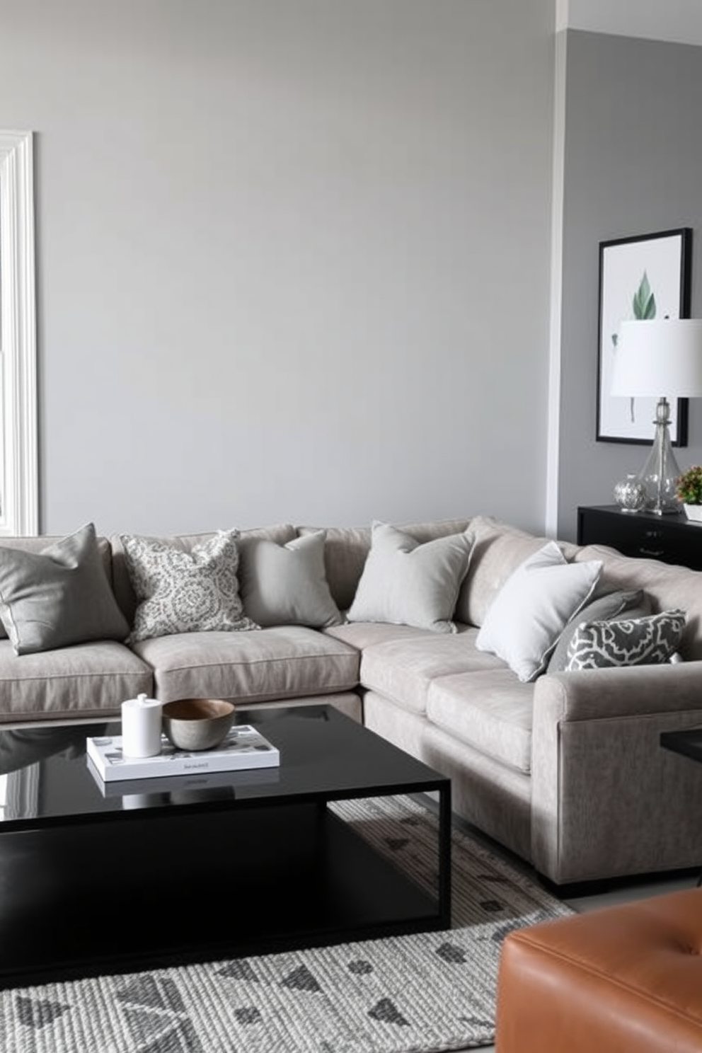 A cozy family room featuring a mix of gray tones in throw pillows scattered across a plush sectional sofa. The walls are painted a soft gray, complemented by a sleek coffee table and a textured area rug that ties the space together.