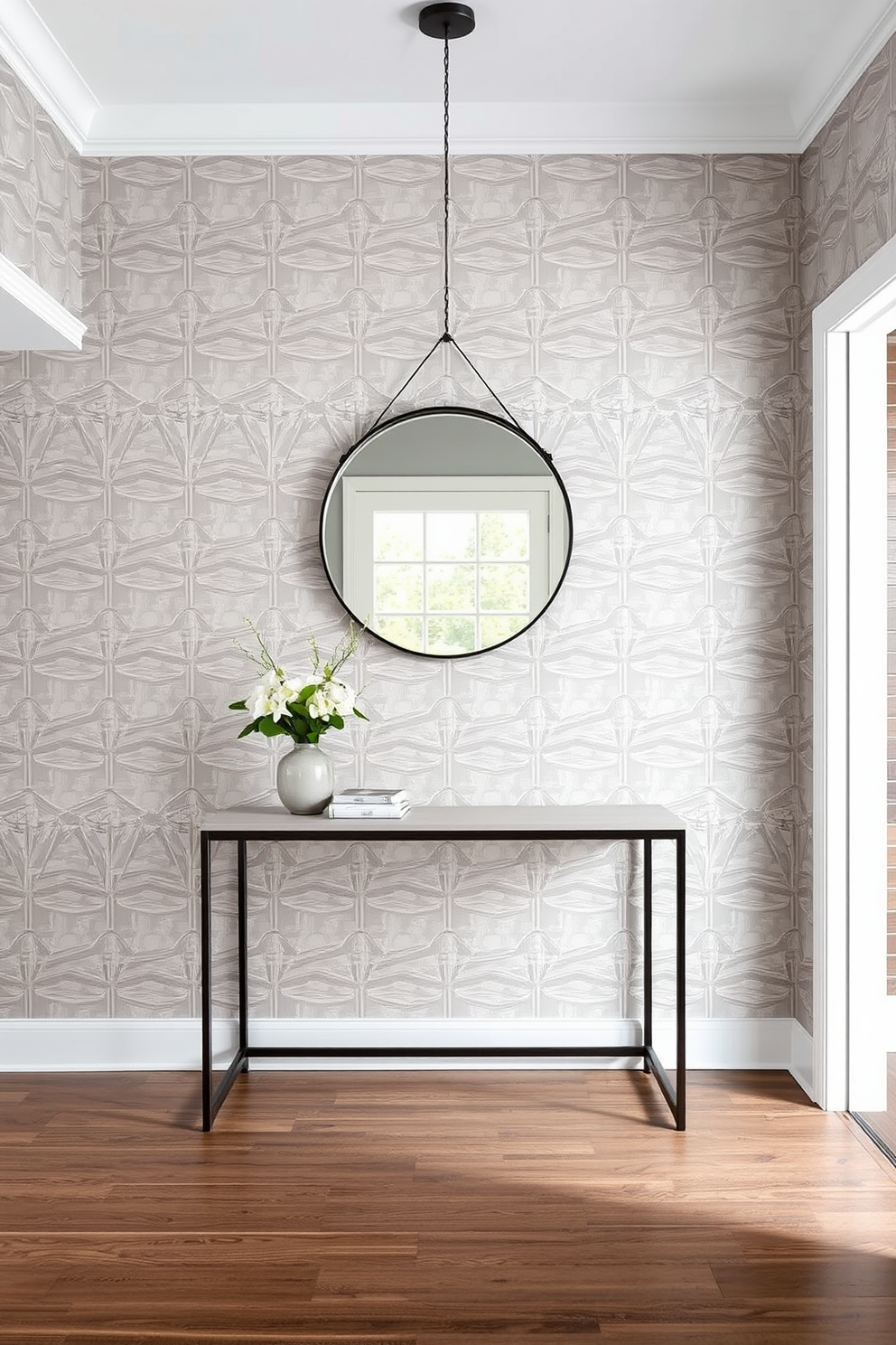 A luxurious foyer with gray walls adorned with elegant gold accents. A plush gray rug lies beneath a stunning chandelier that features gold detailing, creating a warm and inviting atmosphere.