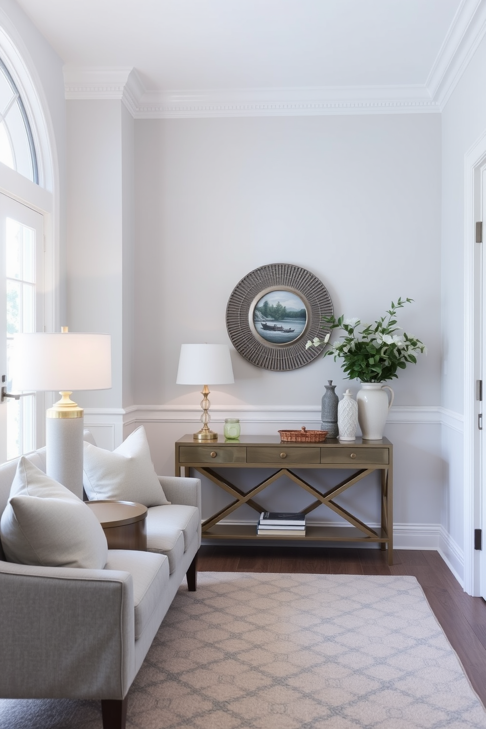 A stylish foyer adorned with gray floral arrangements creates a fresh and inviting atmosphere. The walls are painted in a soft gray hue, complemented by a sleek console table and a large round mirror above it. The floral arrangements feature varying shades of gray and white blooms, elegantly displayed in a modern vase. A plush area rug with geometric patterns lies beneath, adding warmth and texture to the space.